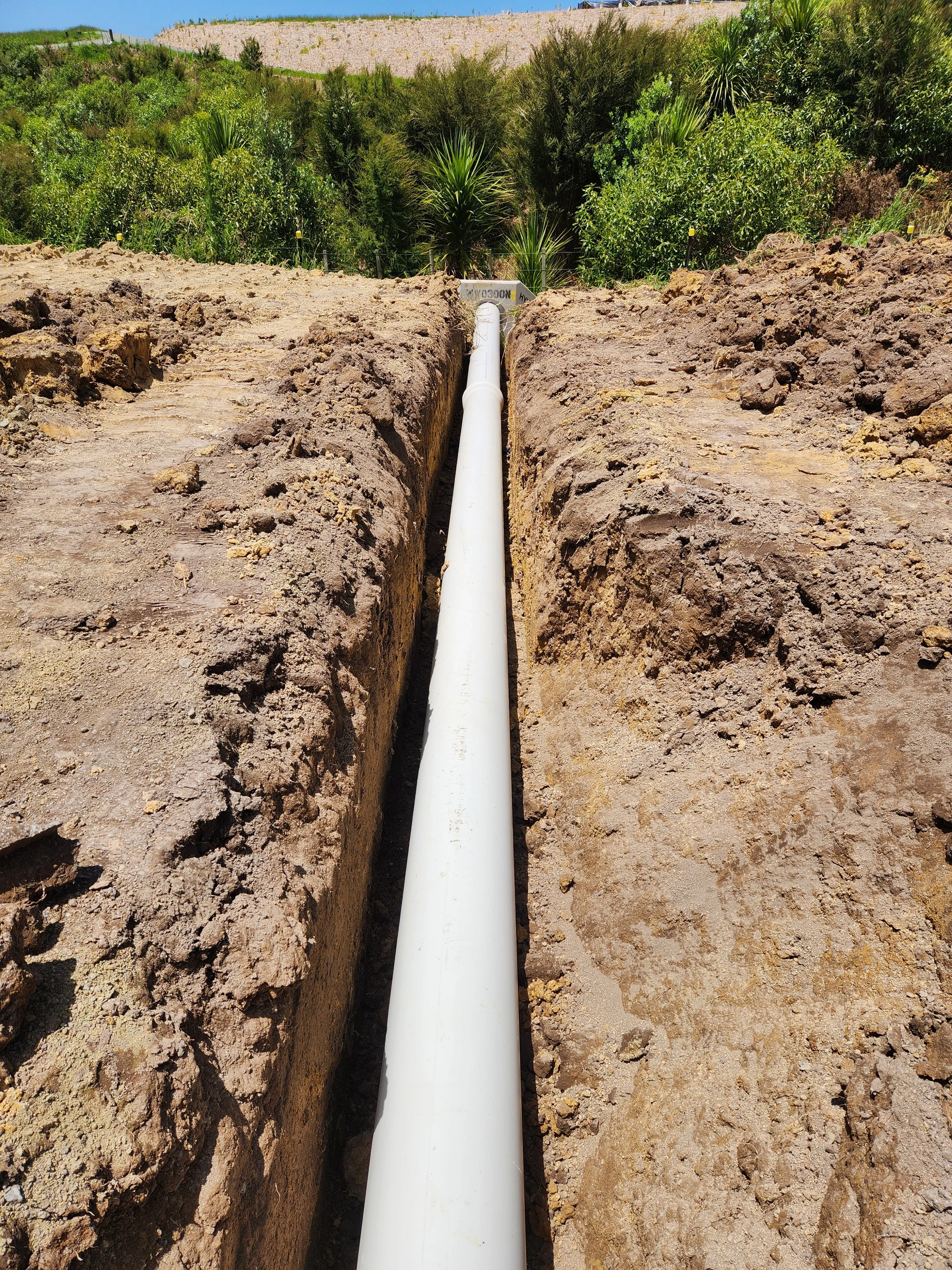 a drainage pipe in a trench to disperse stormwater from a swale drain
