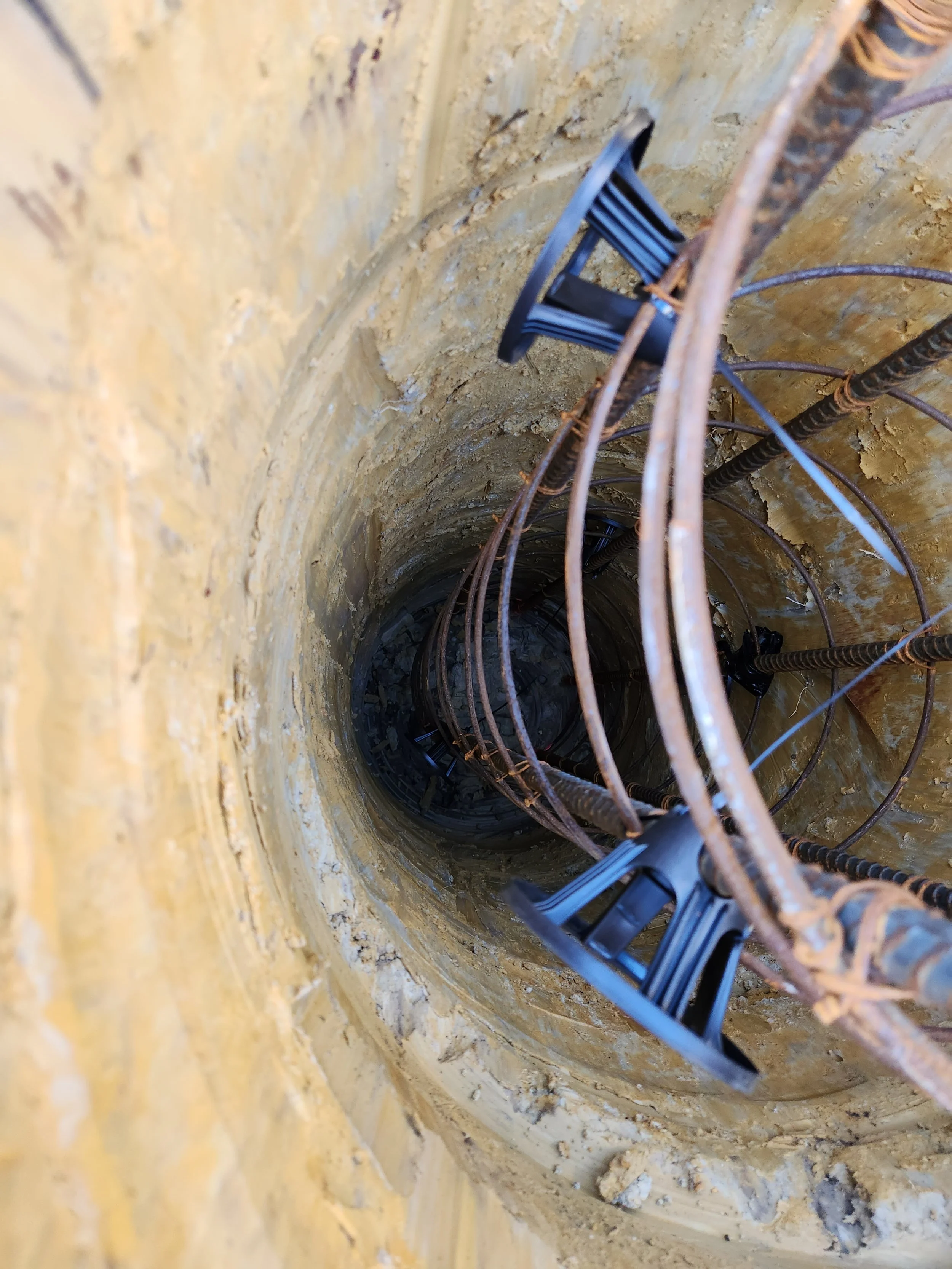 a steel cage in a drilled pile hole for a concrete pile