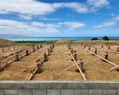 Timber pile foundations and a block wall foundation on an Oxen residential construction site in Auckland