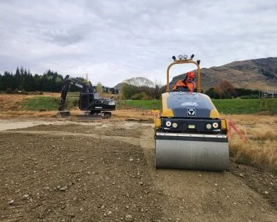 roller compacting metal for building platform on Auckland residential earthworks site run by Oxen limited