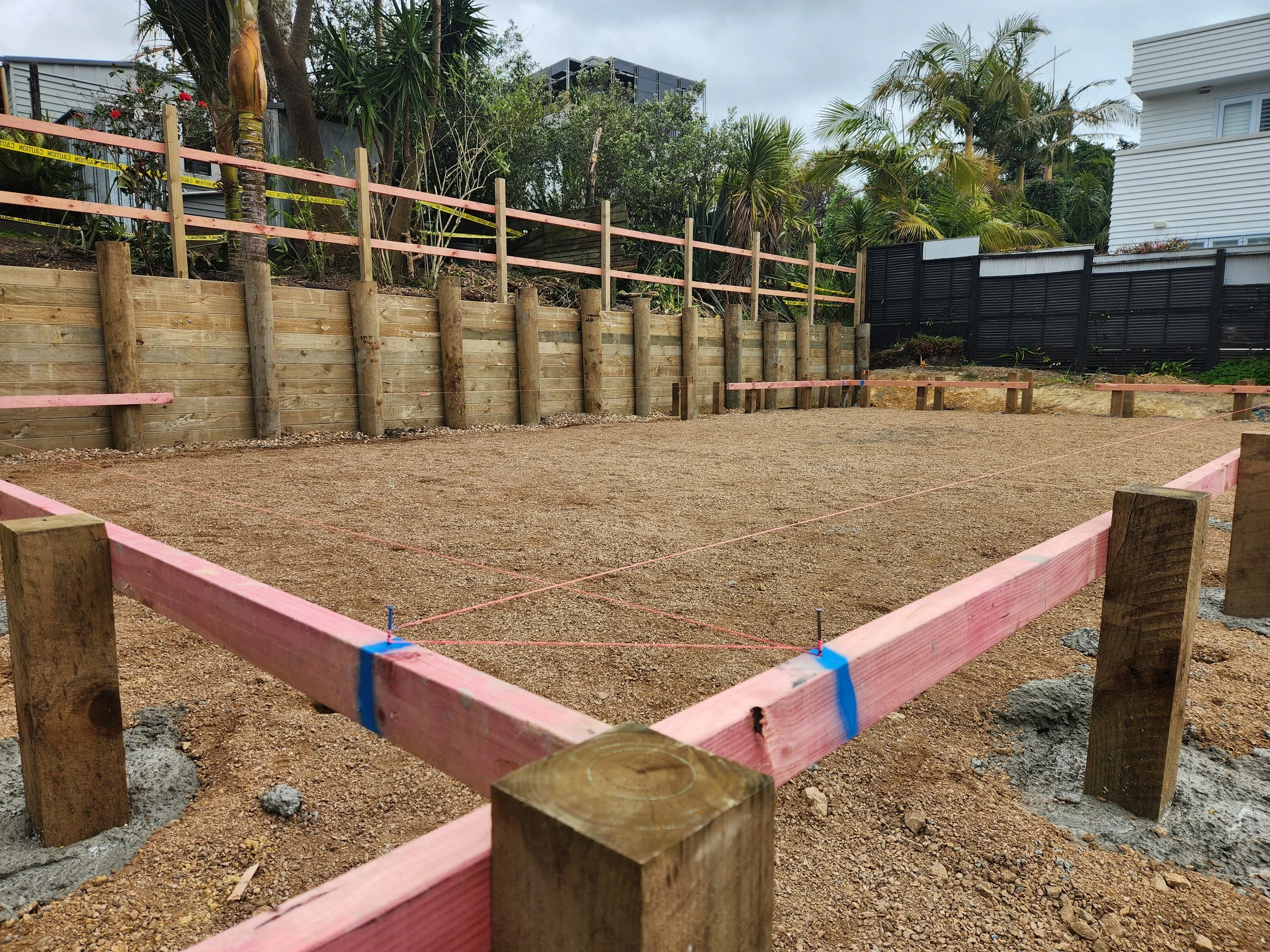 building platform with profiles and a retaining wall in the background
