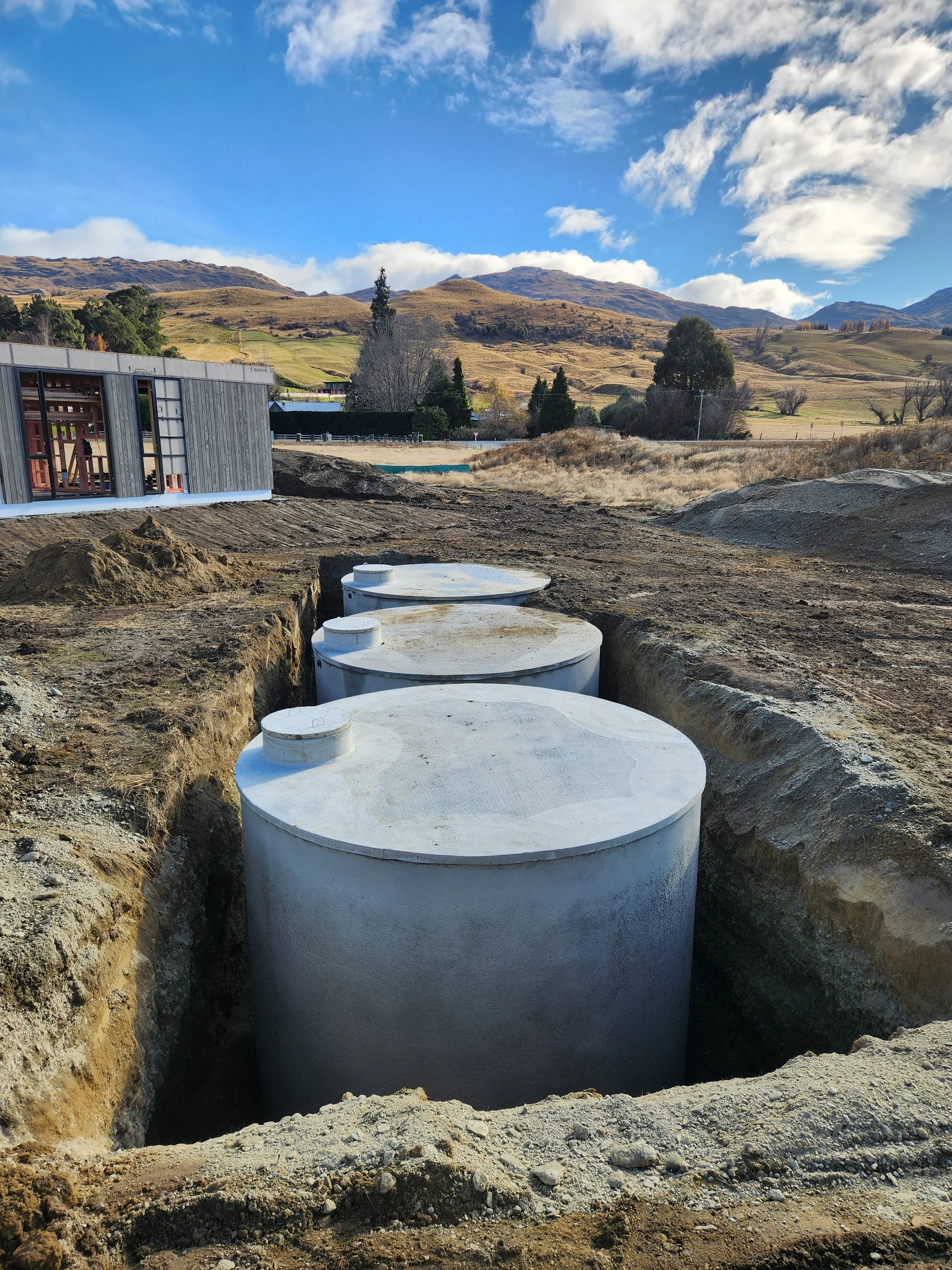 3 concrete rainwater tanks being installed on a lifestyle property