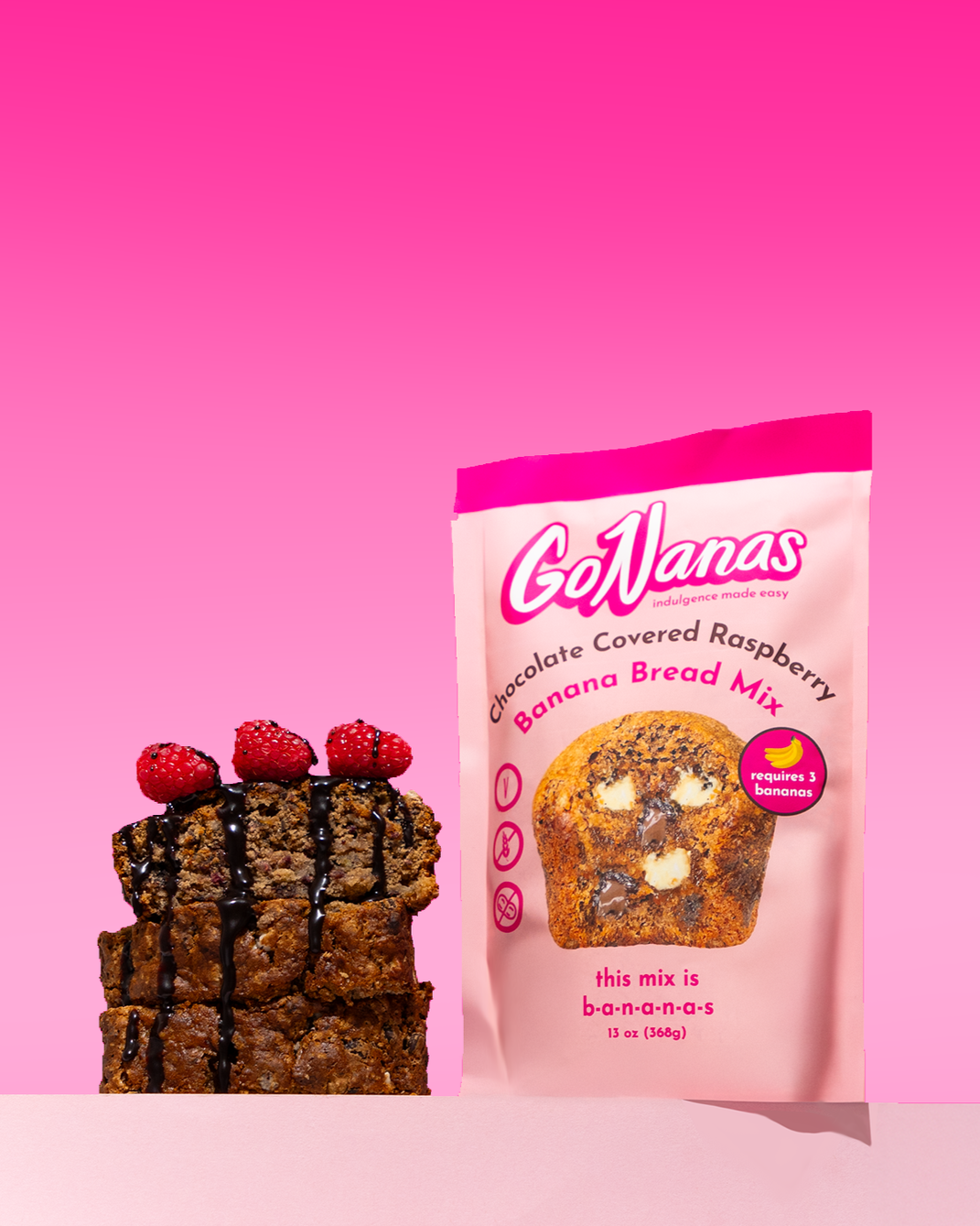 GoNanas banana bread topped with raspberries and drizzled with chocolate. Commercial product photography for CPG, food, and beverage brands, creating e-commerce, social media, and marketing-ready product images.