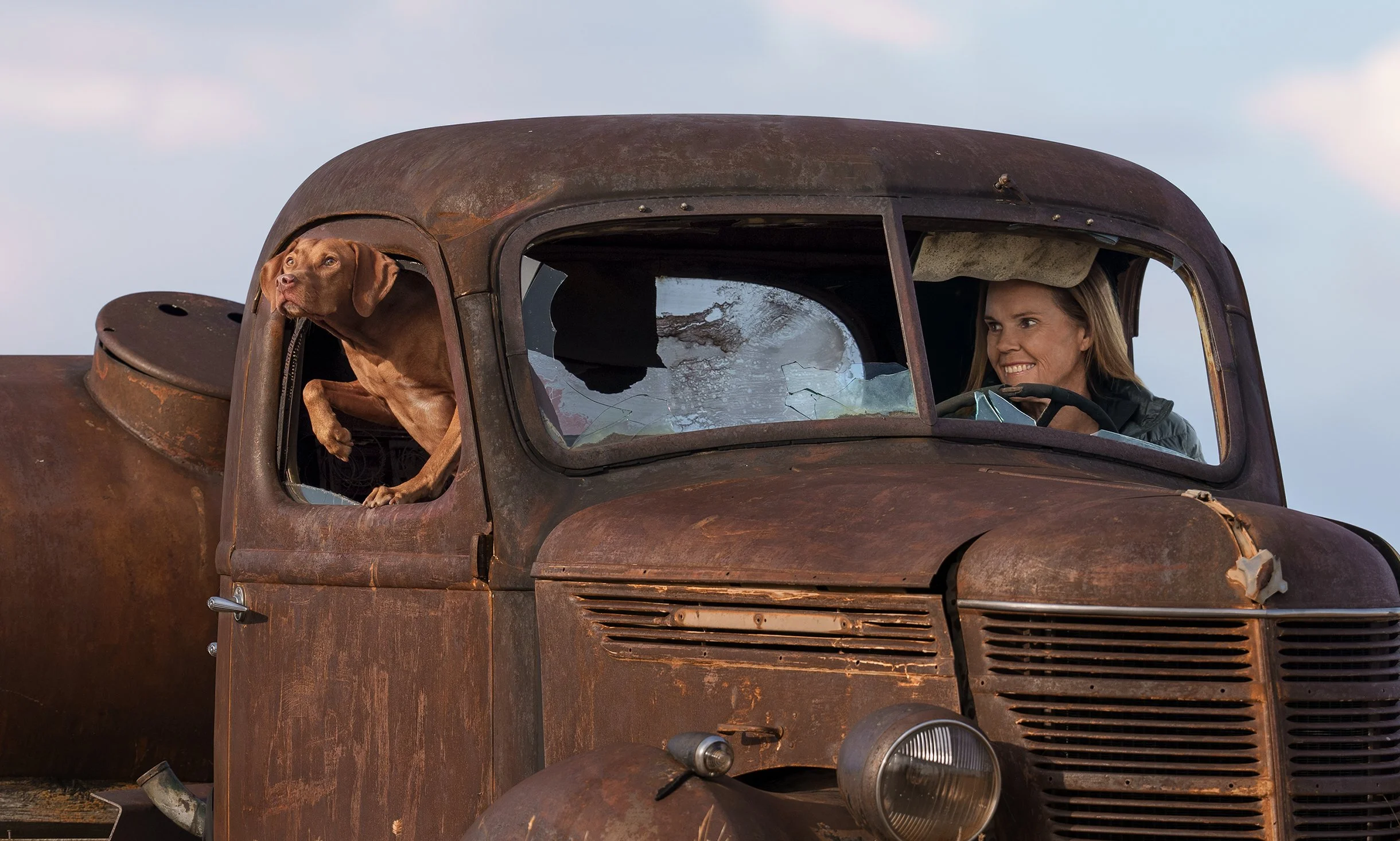 Photographer Jessica Carlson and her Vizsla in a vintage farm truck