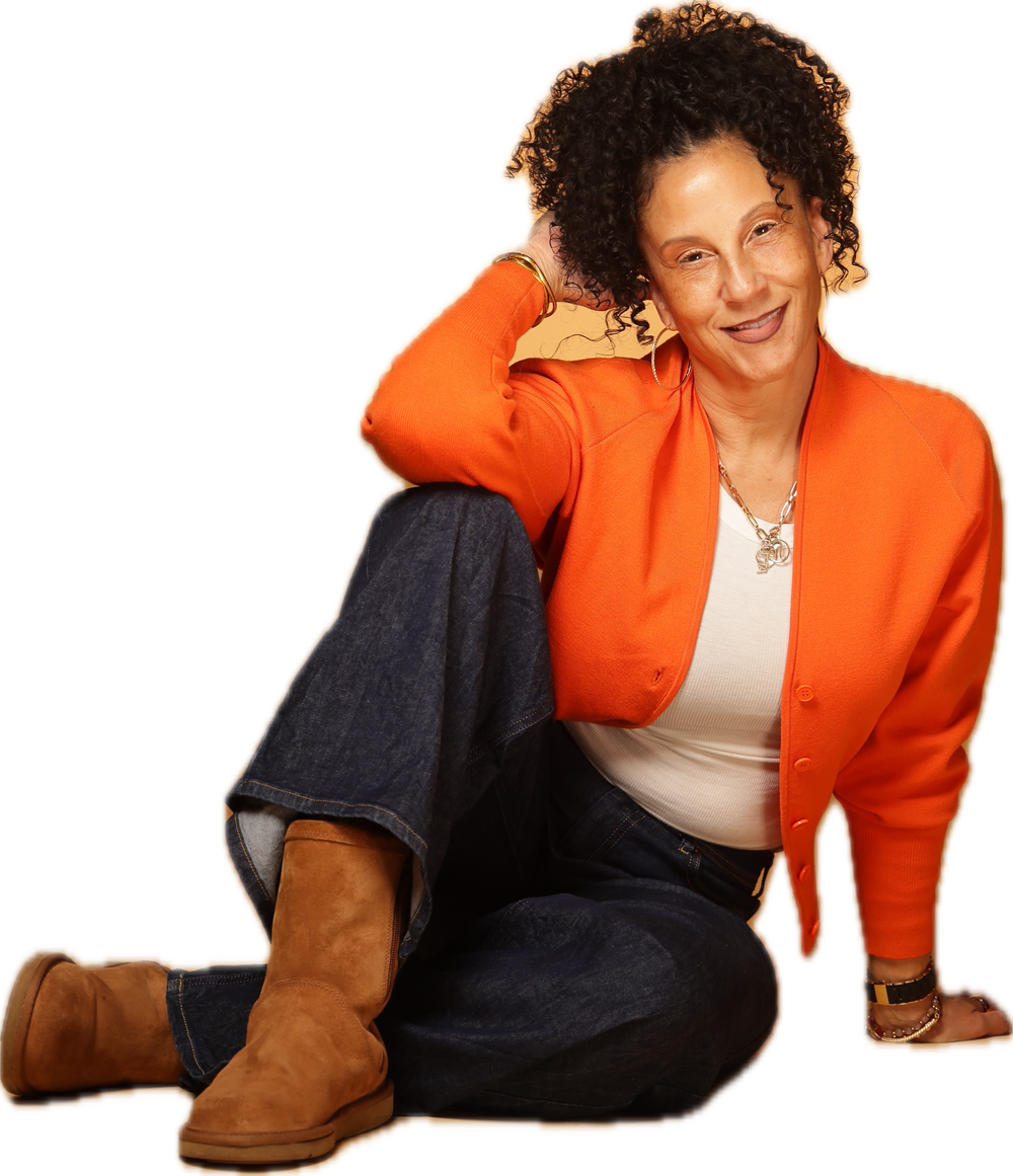 Dr. Cara Alexander, seated, in an orange cardigan