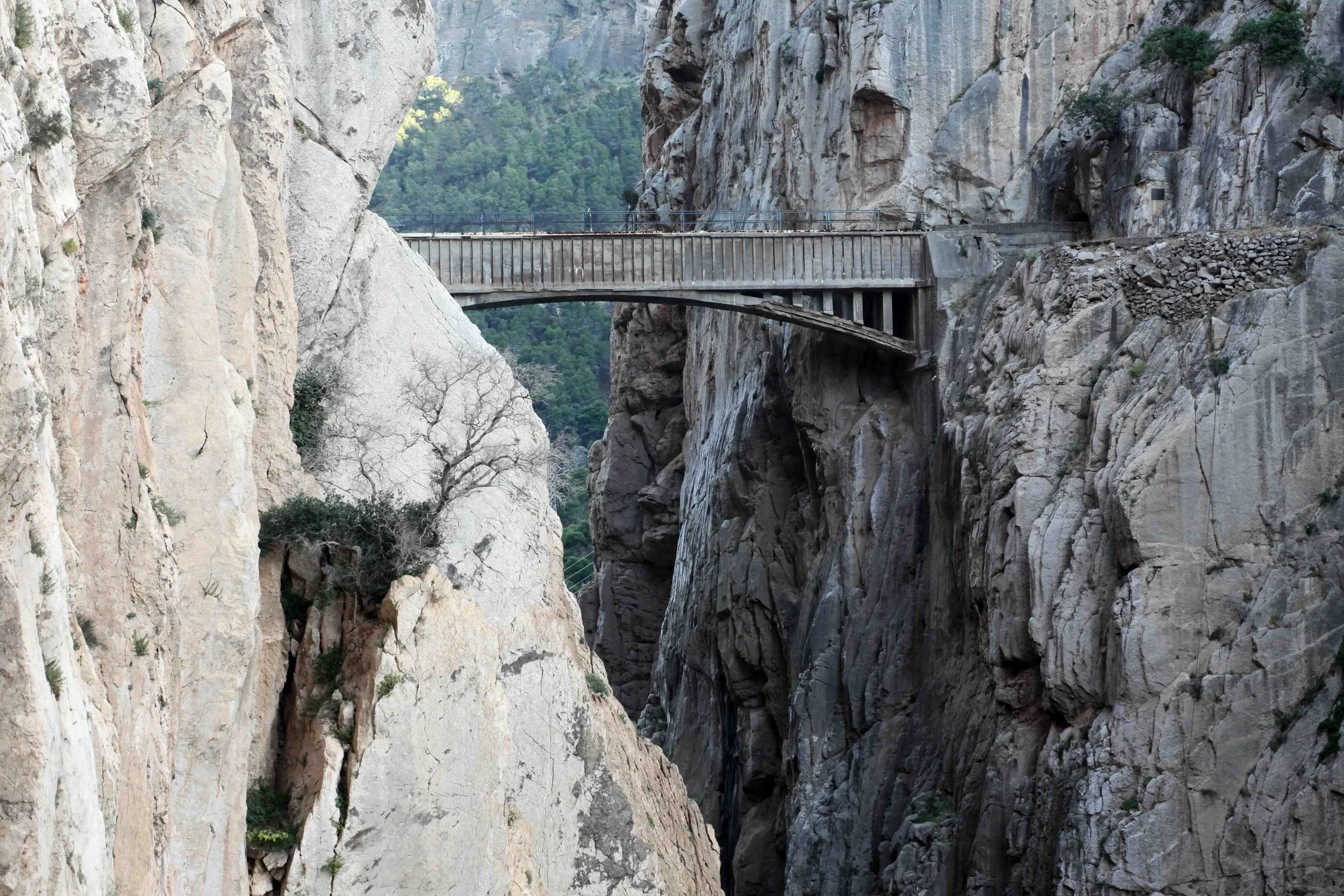 Old bridge over a deep rocky crevasse