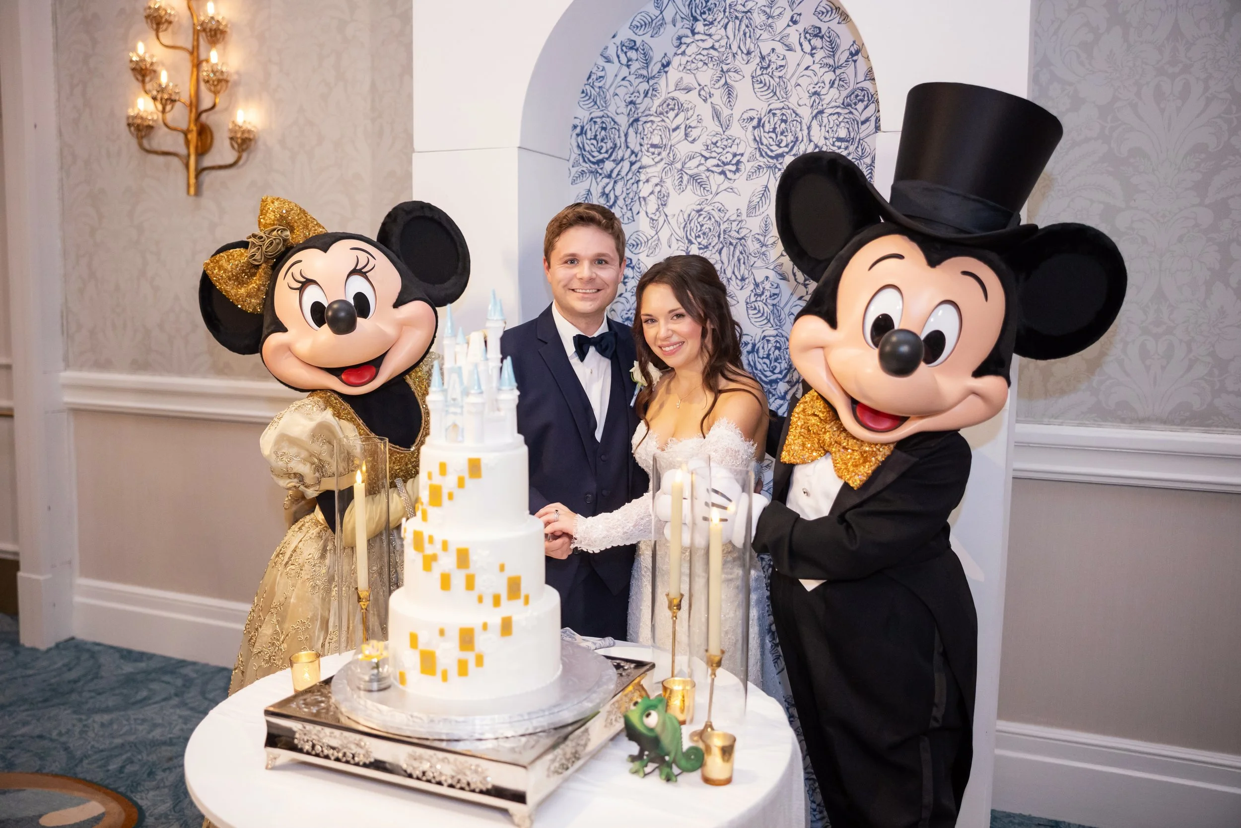 Bride and Groom Cutting the Cake with Mickey and Minnie