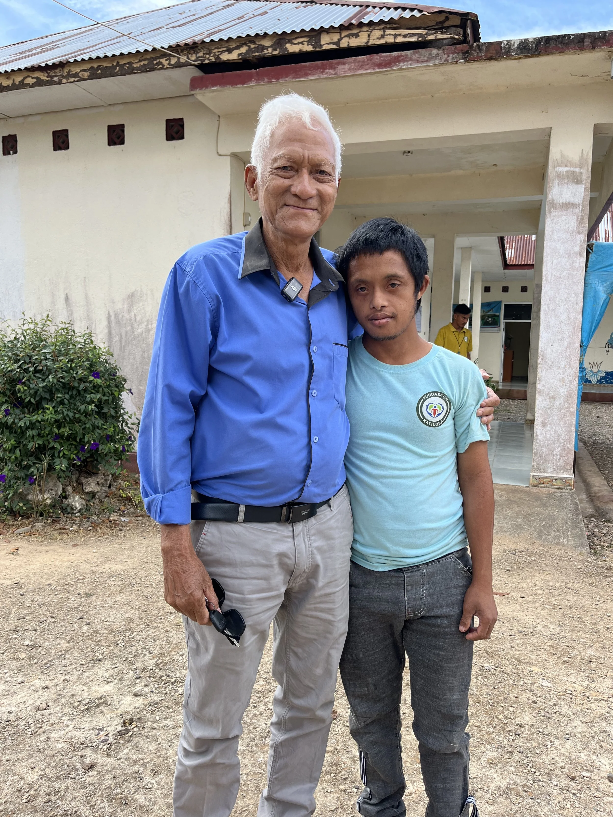 Young David with his Father outside of class. Parenting a child with a disability comes with many challenges in Timor-Leste, stigma being the most challenging to over-come