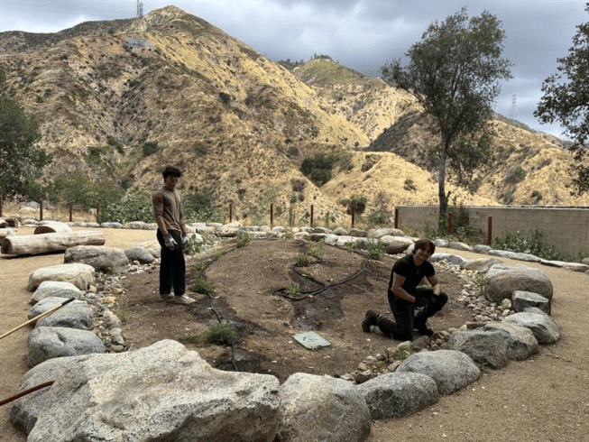 This is a picture of young people caring for the land at Huhuunga.