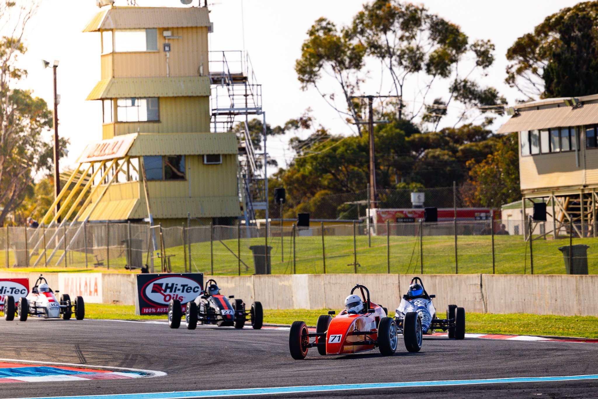 Race cars on a track during a race.