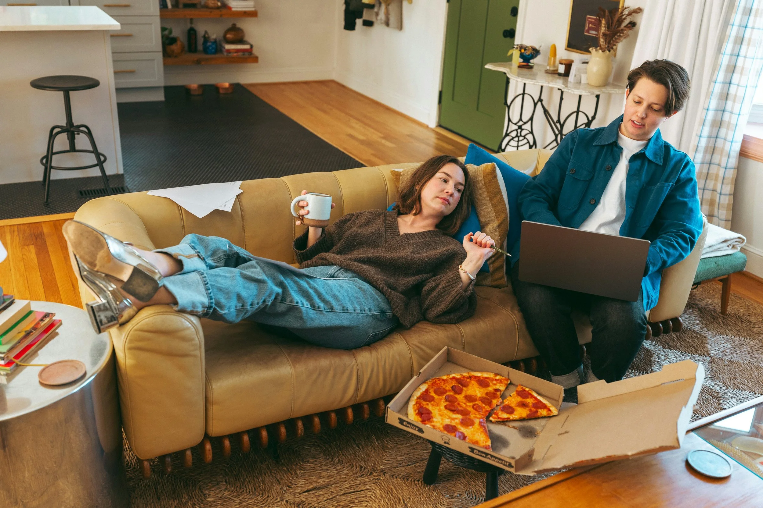 Two friends having a thoughtful conversation on a couch.