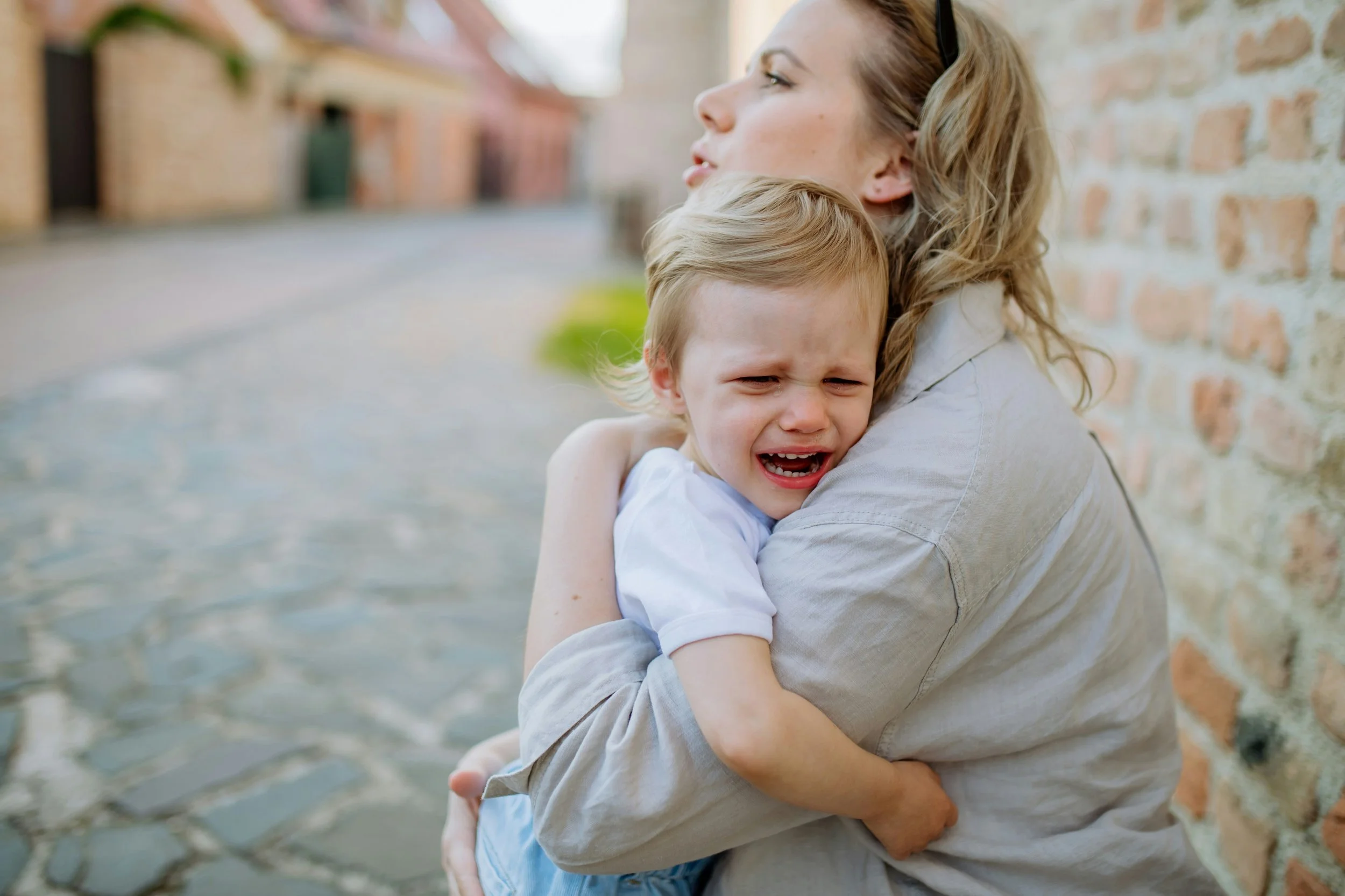 Parent comforting child who is upset while teaching emotional regulation