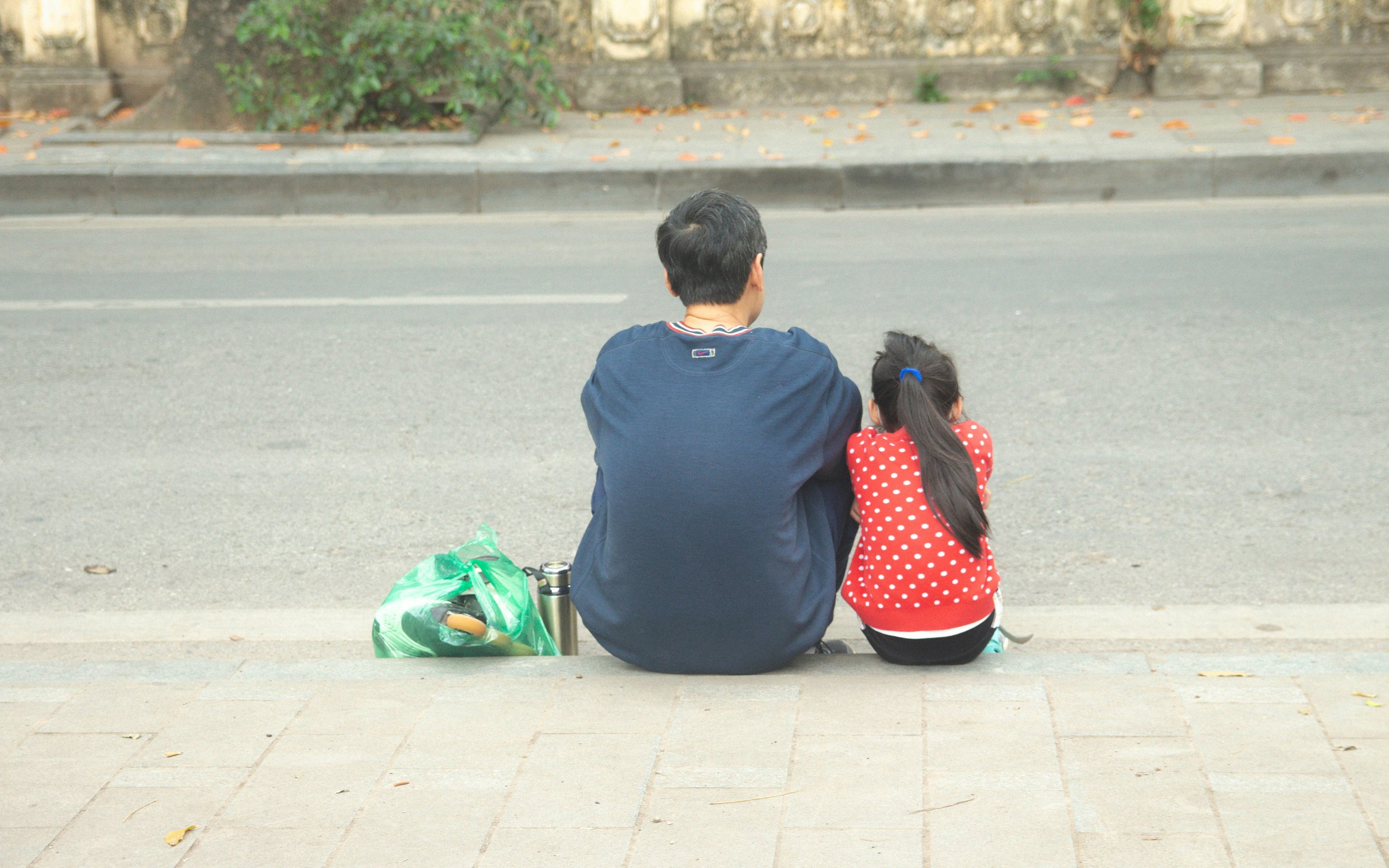 Parent sitting calmly with their child, representing emotional connection and learning to respond to a child's emotions without reacting from hypervigilance.