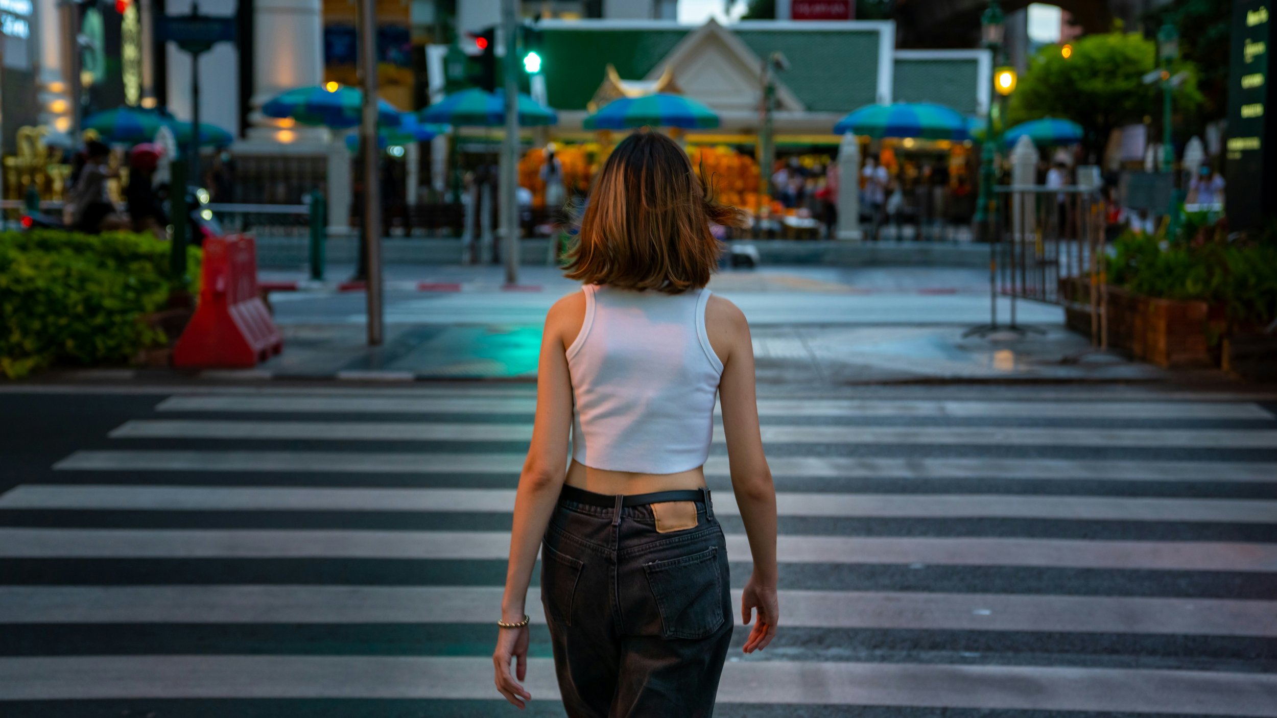 Thoughtful woman walking down the street while considering body image, weight loss culture, self-esteem, social comparison, and the mental health impact of the Ozempic era