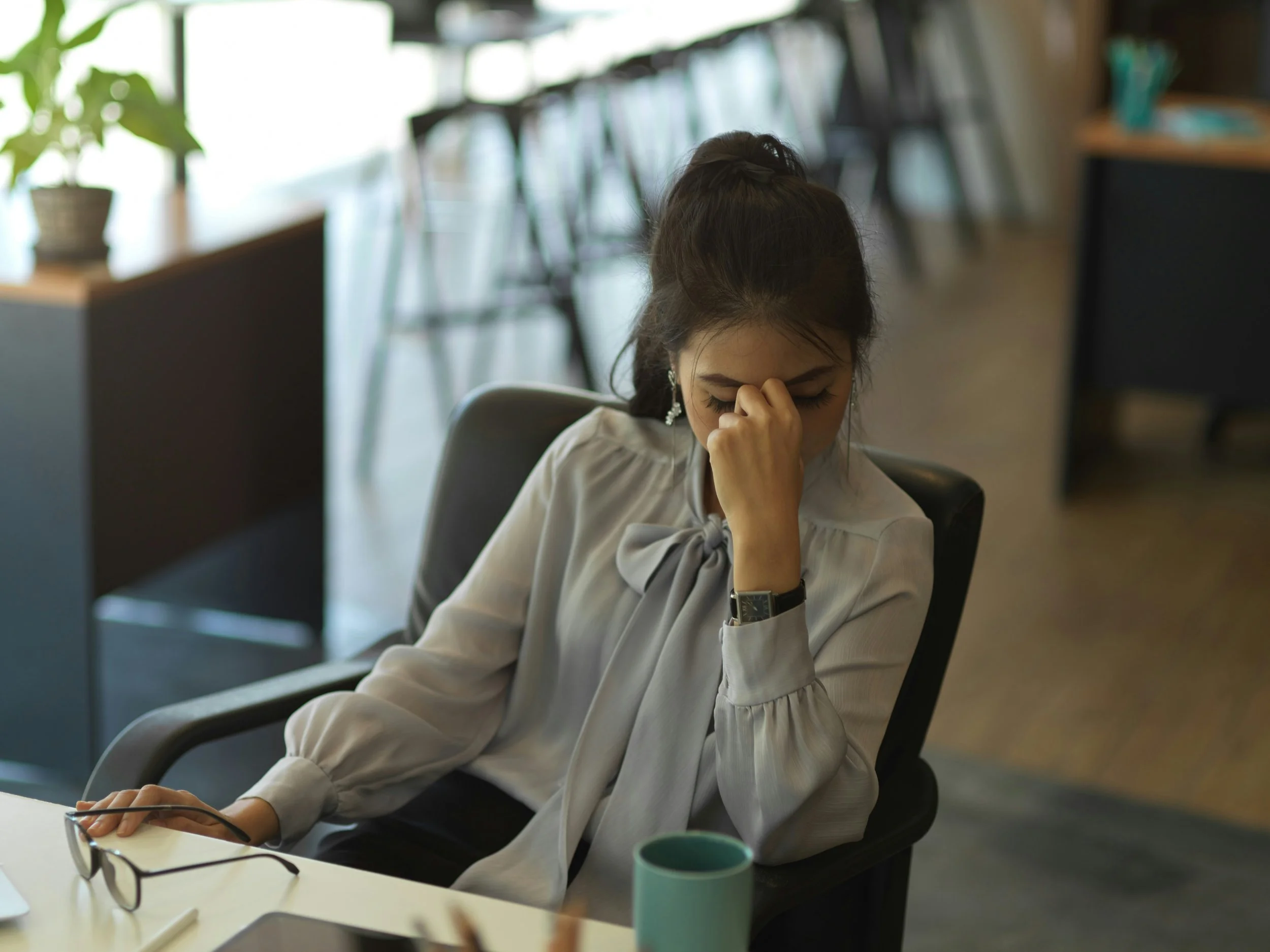 Woman looking stressed while checking phone notifications, representing anxiety and chronic sense of urgency.