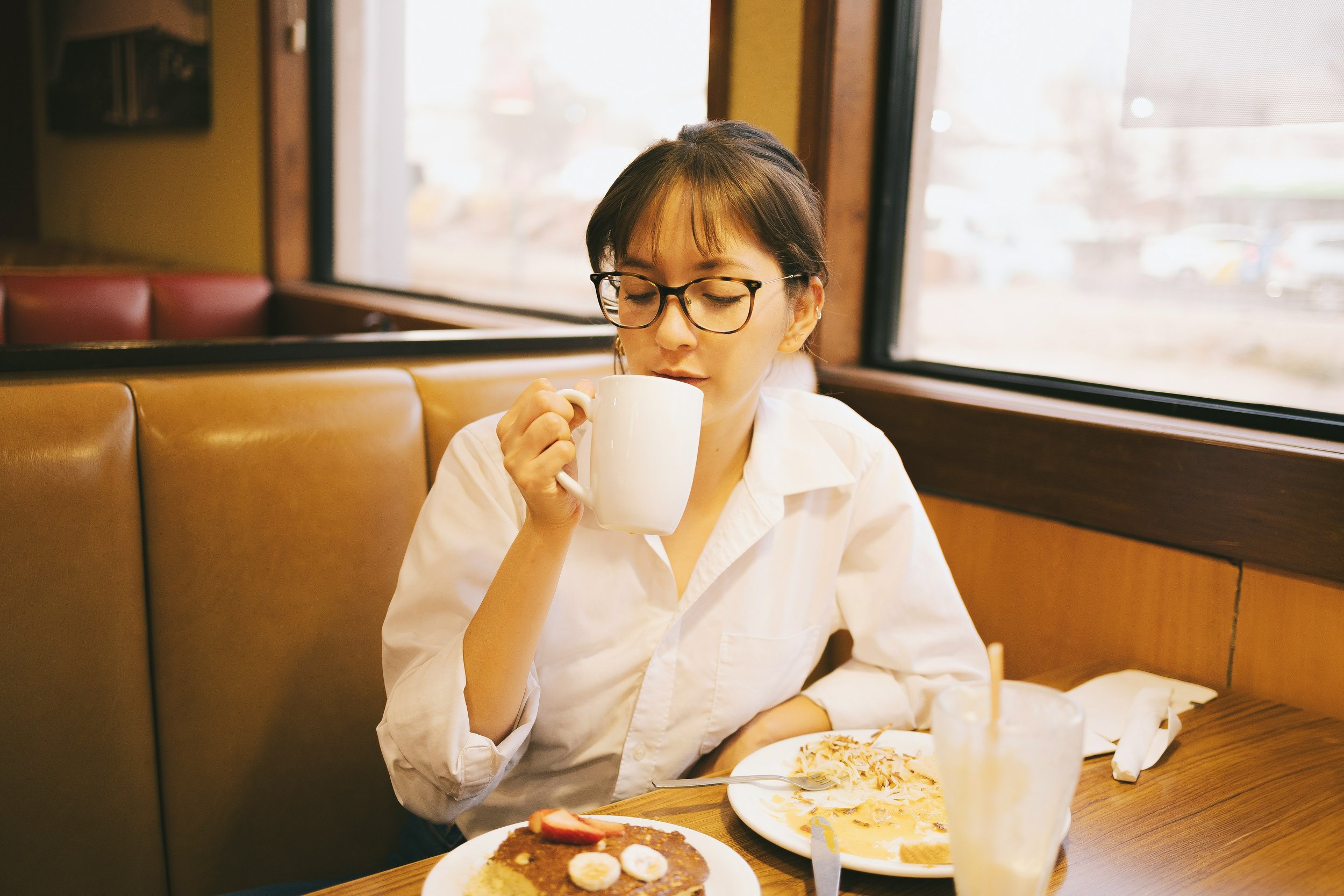 Woman enjoying coffee alone at a cafe.
