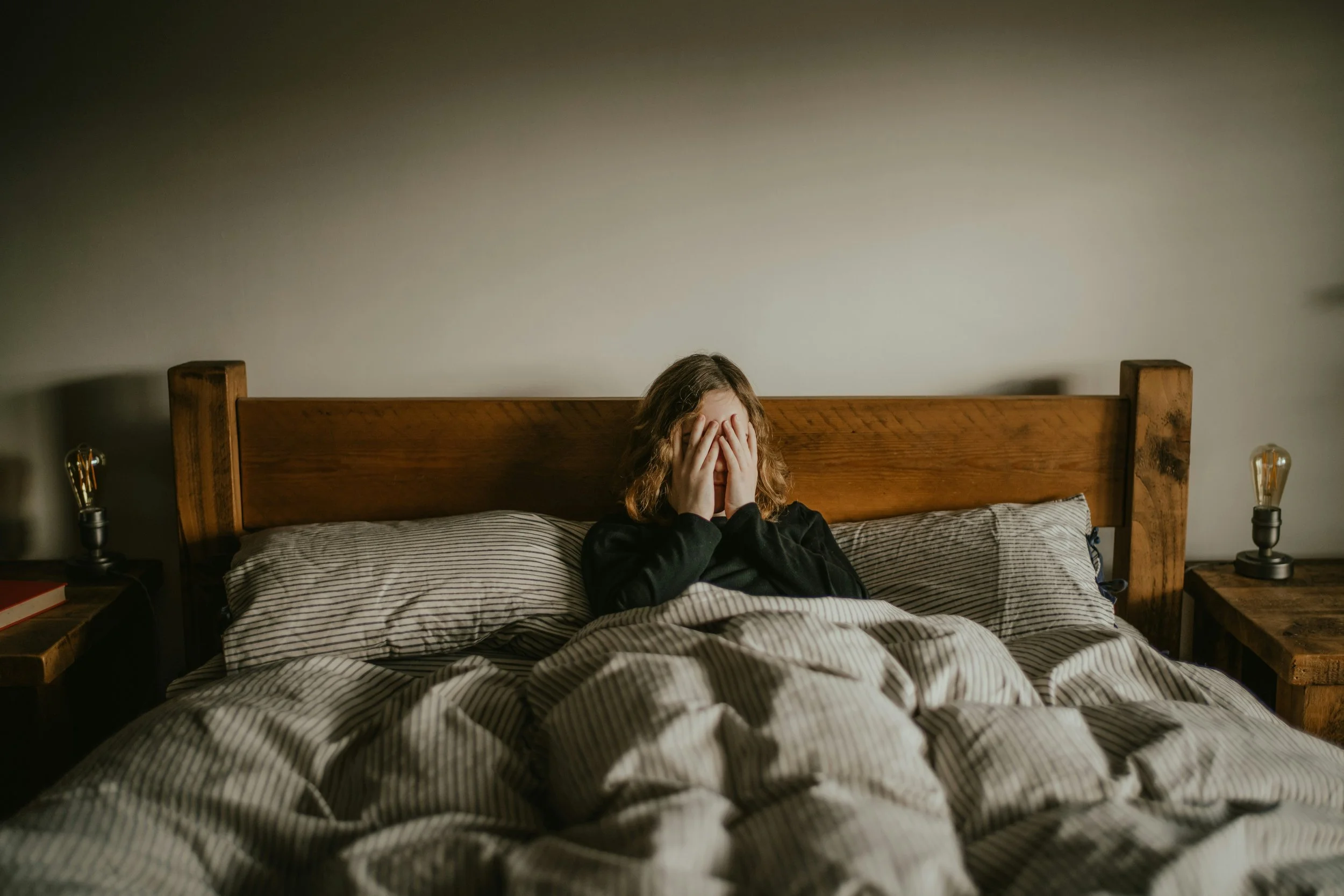 Empty side of a bed representing the absence left after a relationship ends.