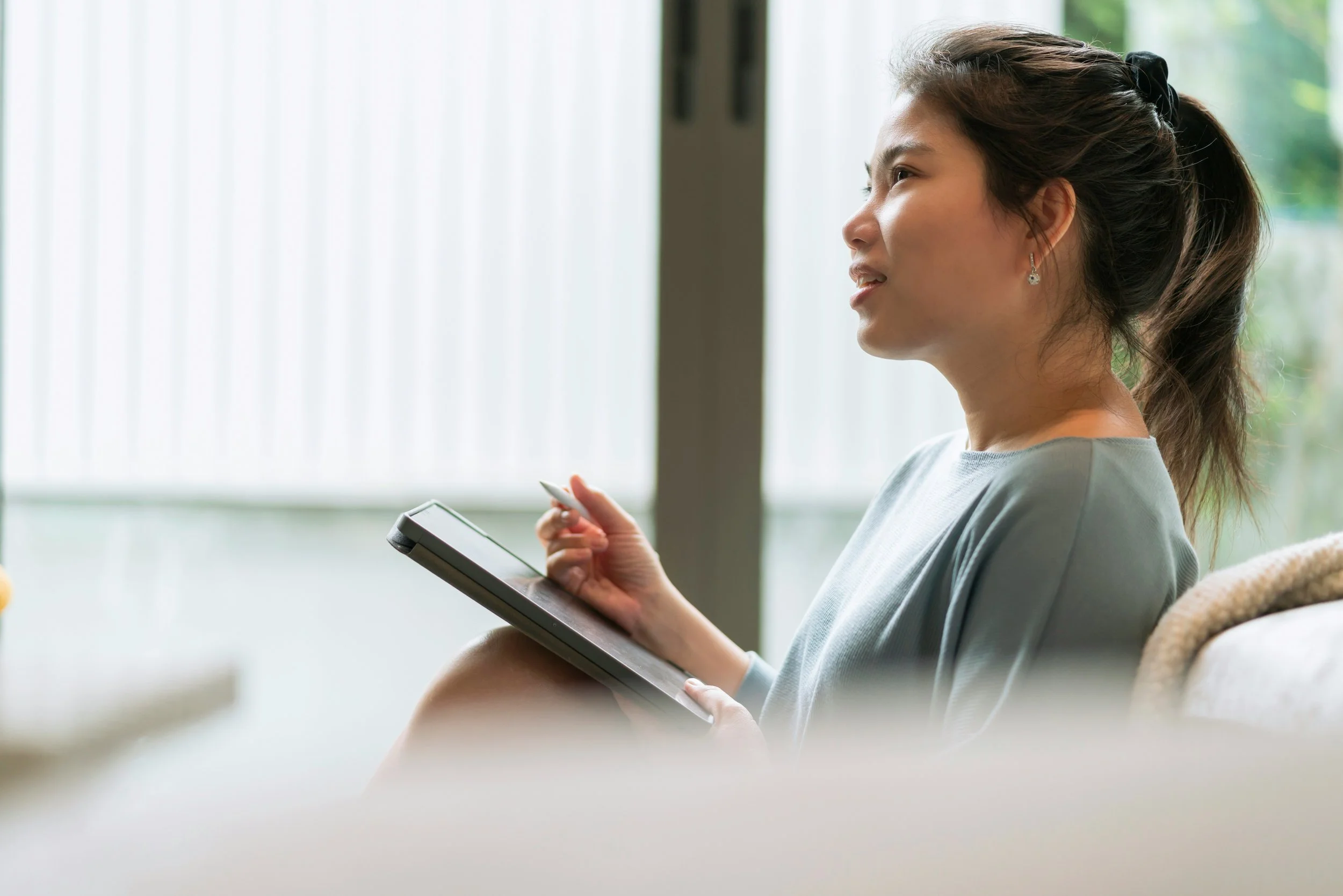 Person sitting thoughtfully in a calm environment, appearing emotionally distant, representing the experience of explaining emotions without fully feeling them
