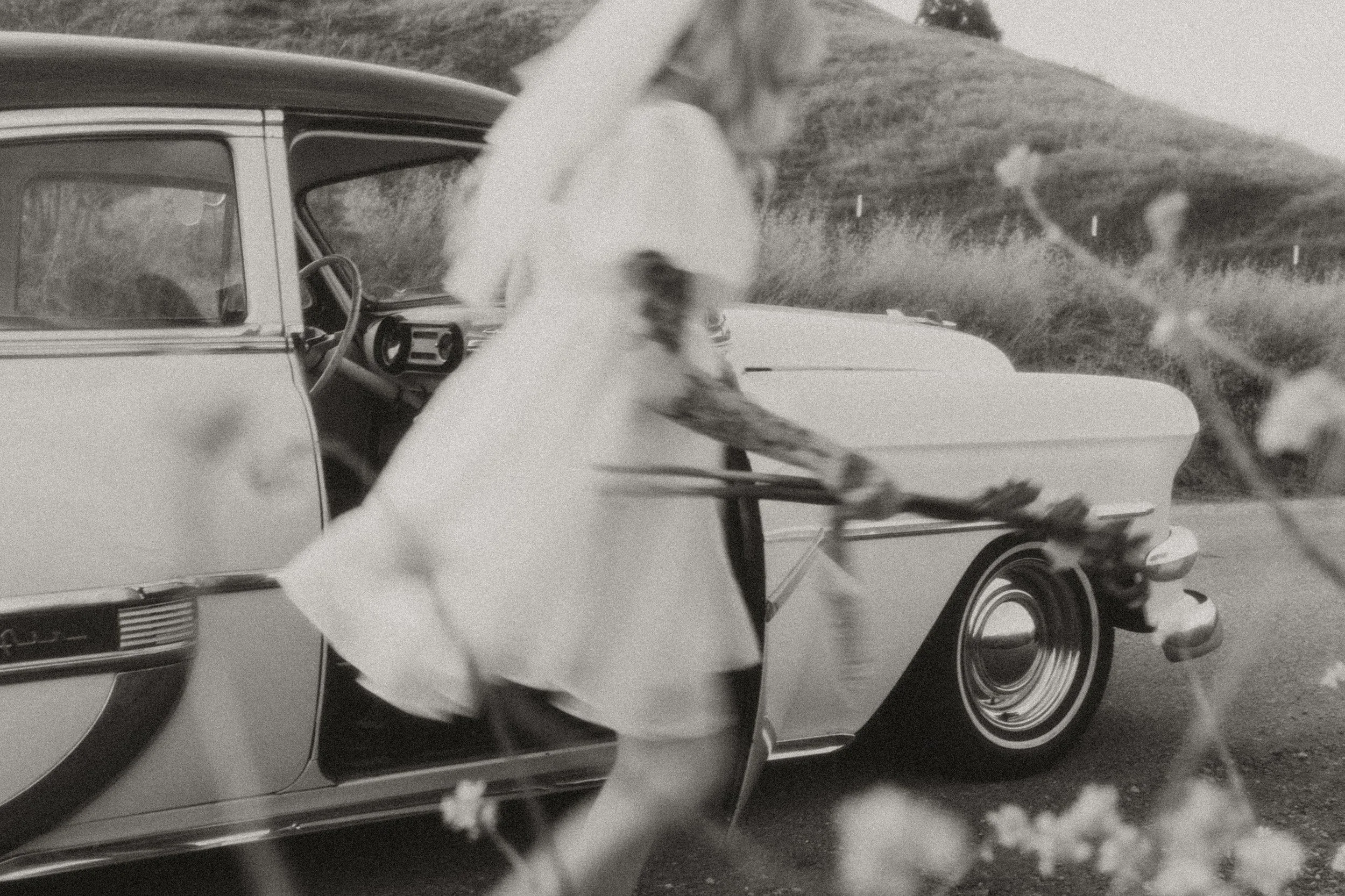 Bride stepping out of a vintage car on her elopement day