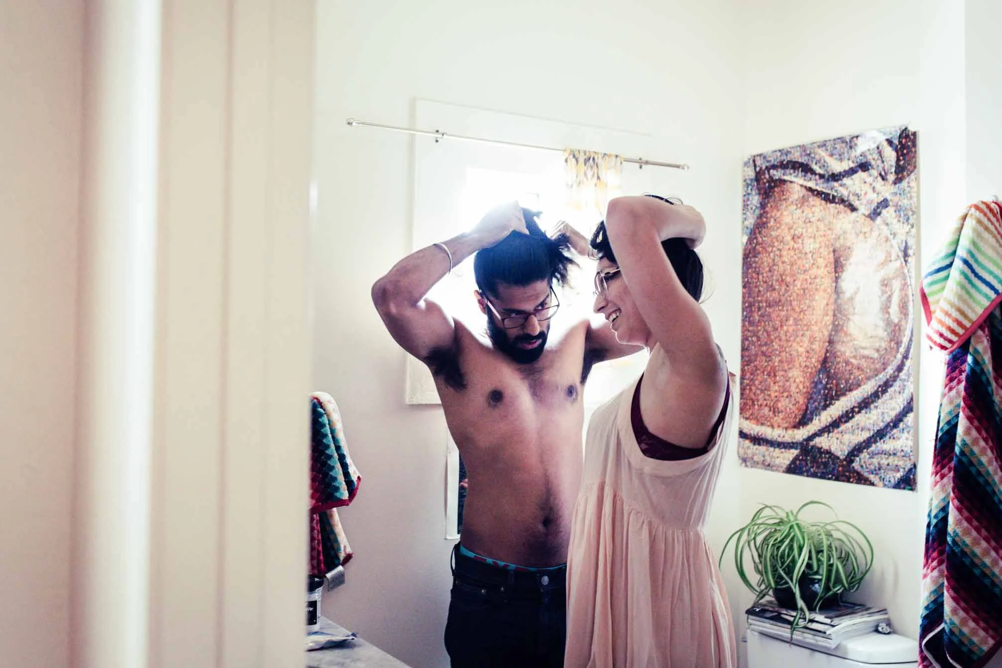 Couple getting ready together in a sunny room, candid in-home photo