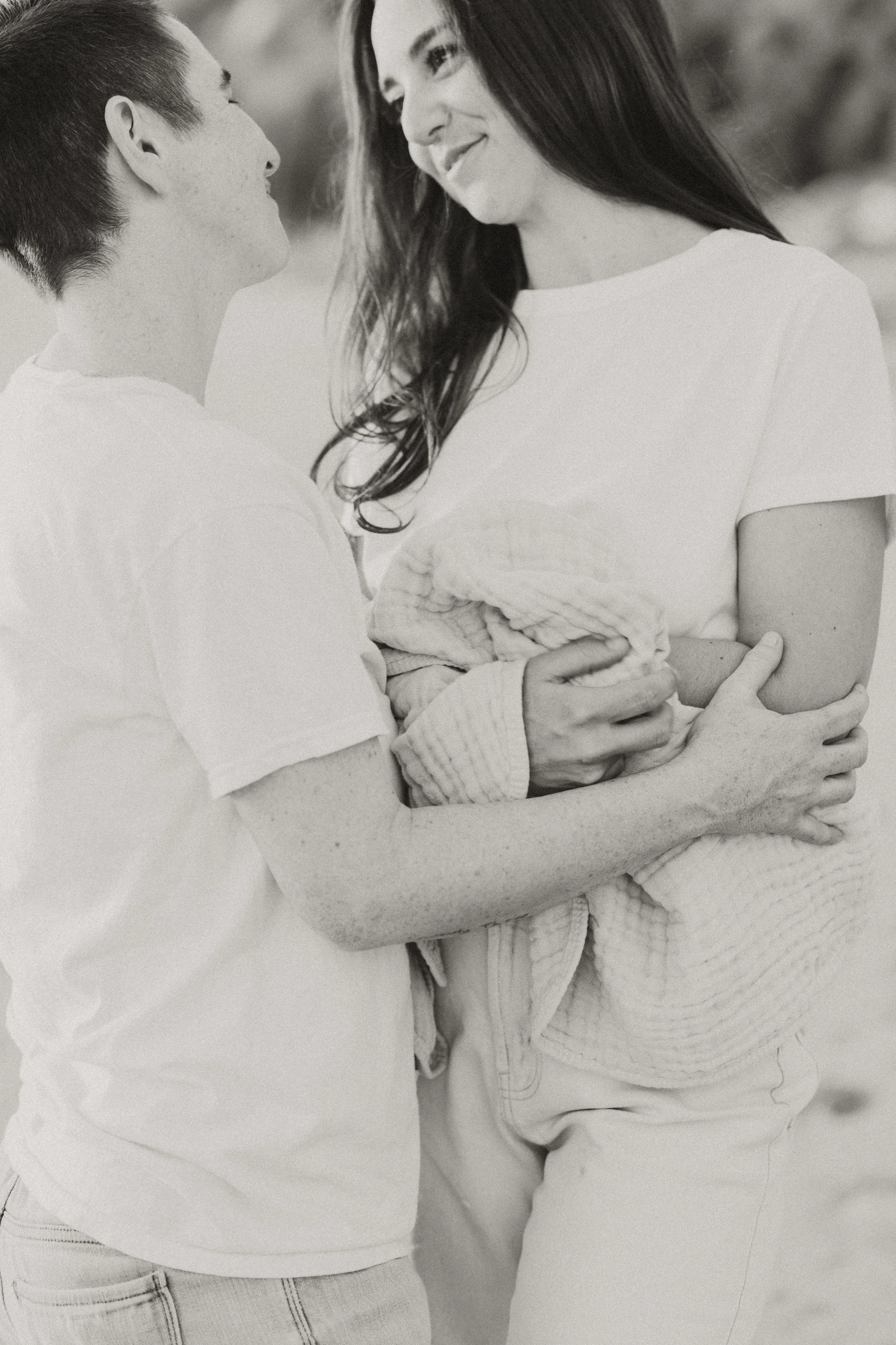 Black and white portrait of a couple holding each other close
