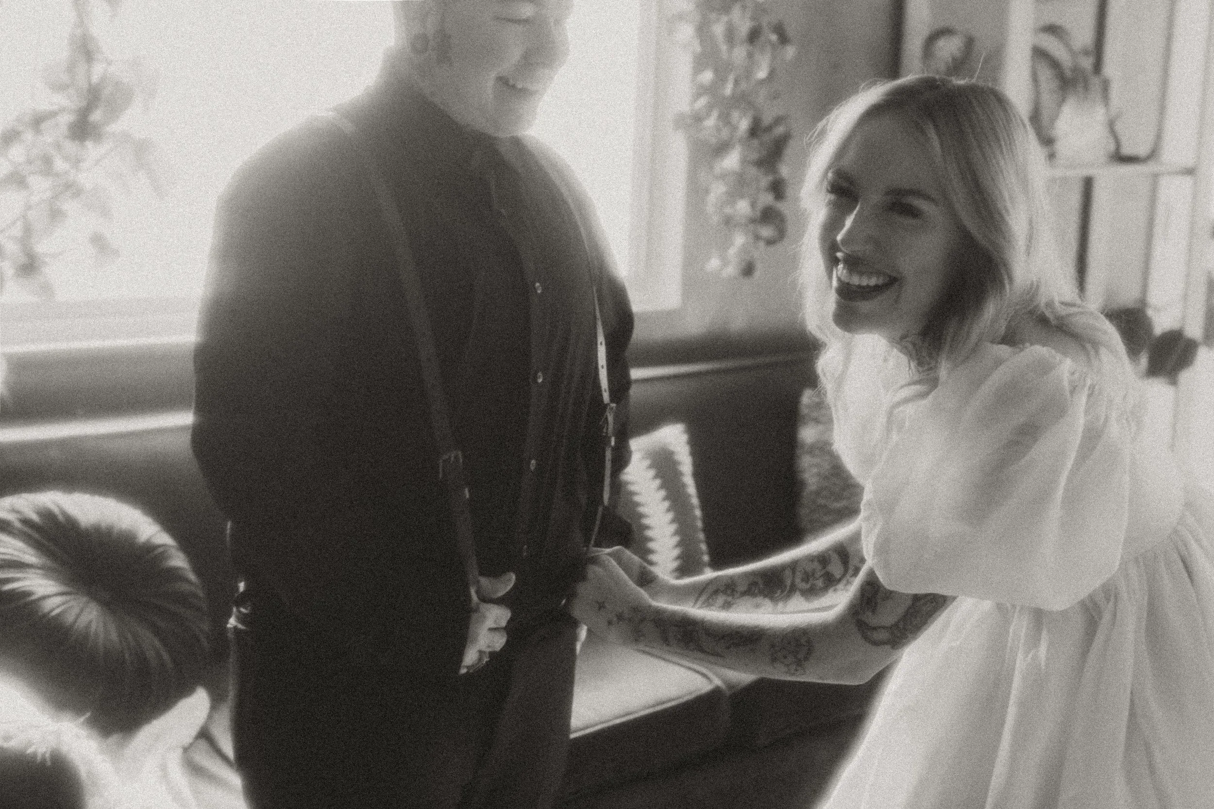 Black and white candid of a couple getting ready for their elopement
