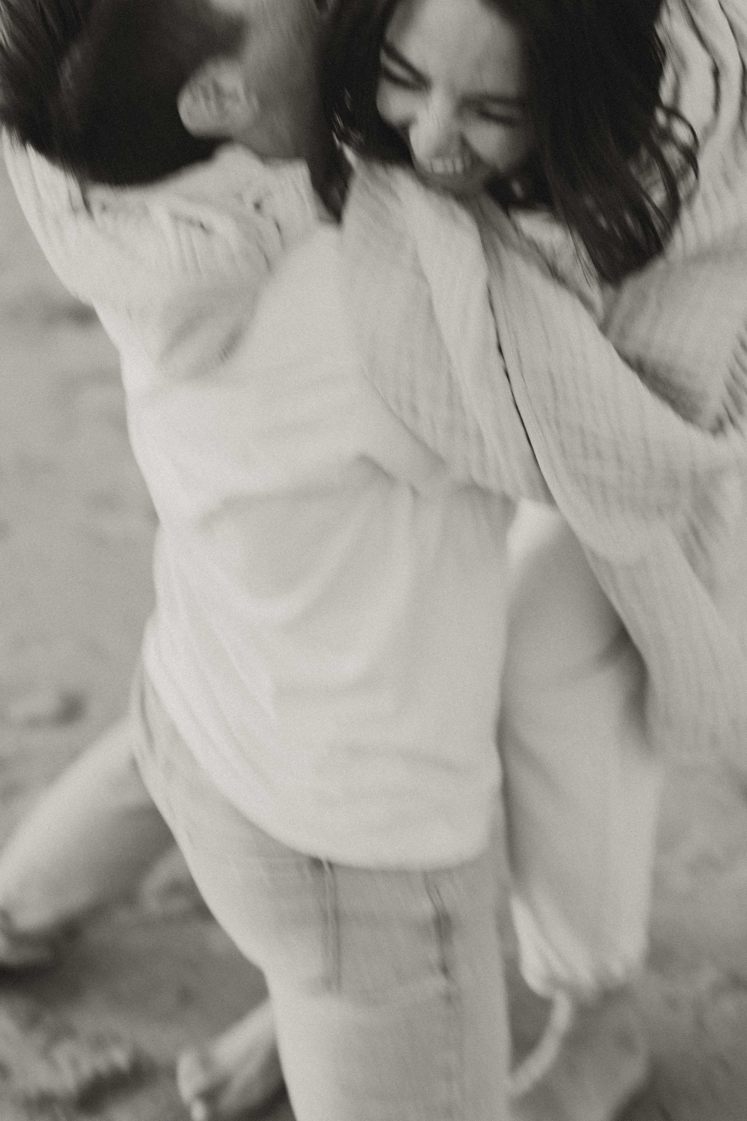 Black and white candid of a couple embracing and laughing