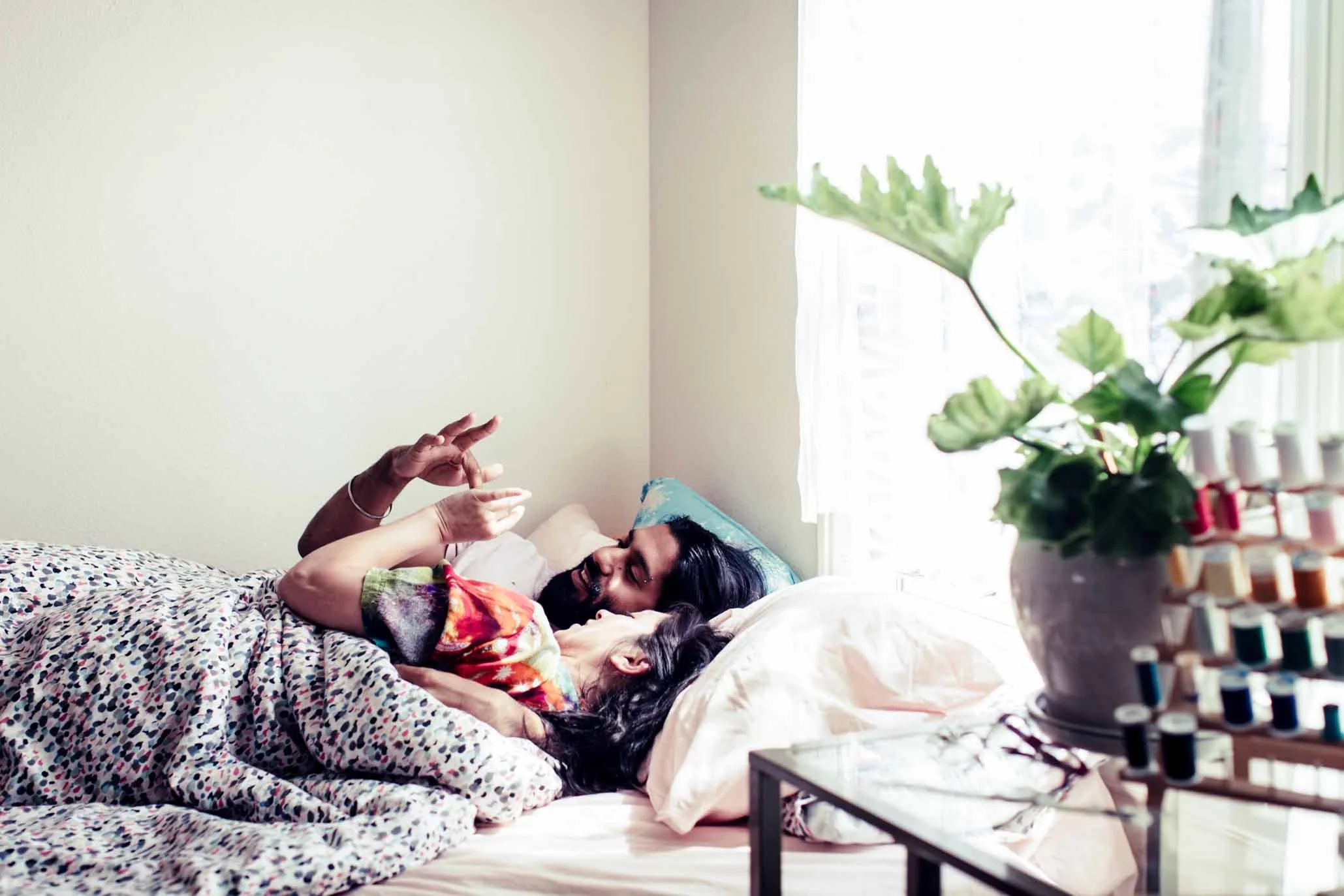 Couple cuddling and laughing on the floor in an at-home lifestyle session