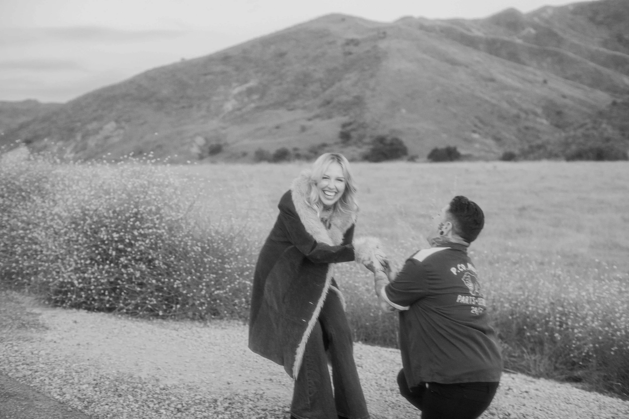 Surprise proposal on one knee in the rolling hills