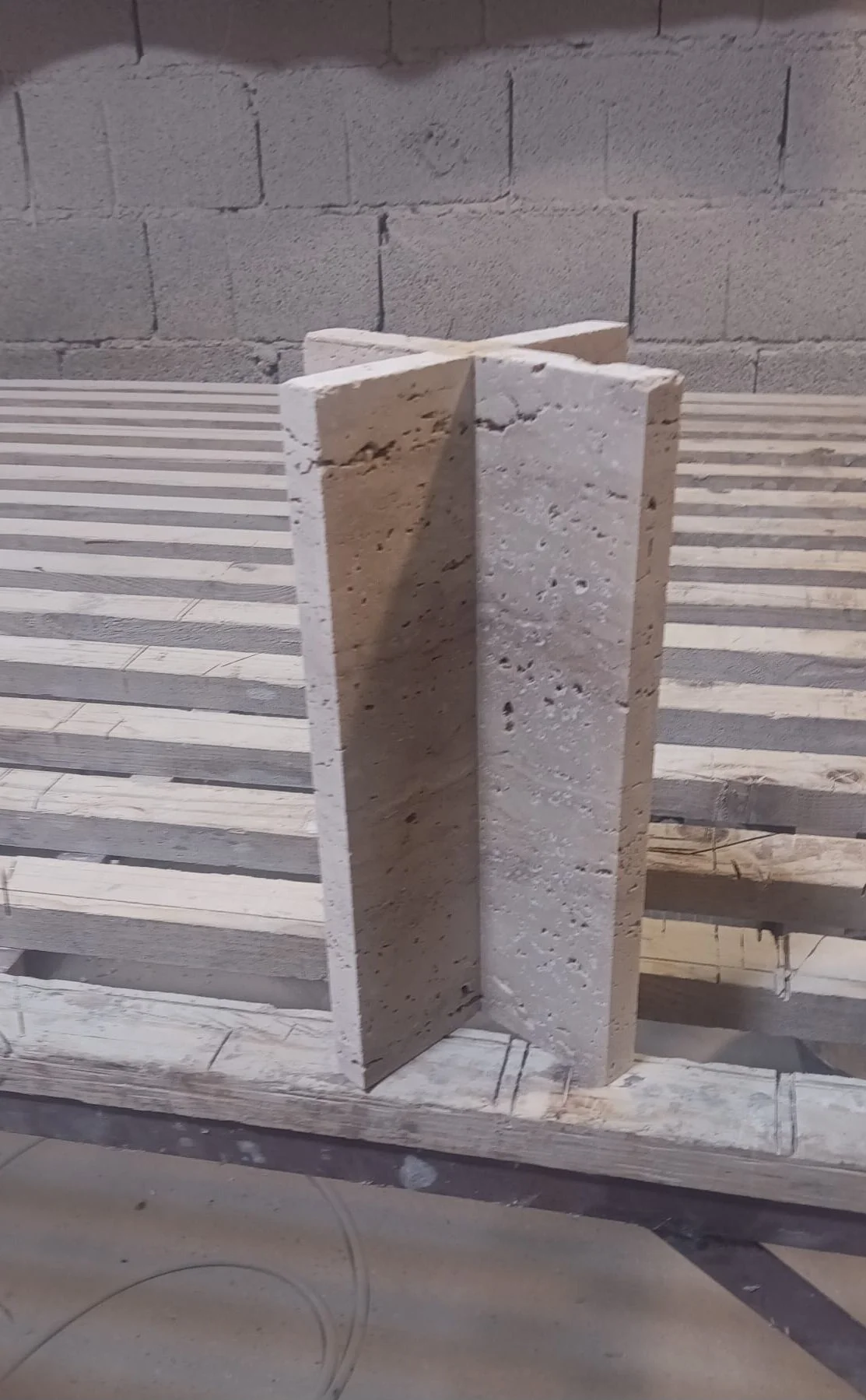"Raw travertine stone block being shaped for the Gerta lamp base, SILENCE collection, at the Ebba Design workshop"