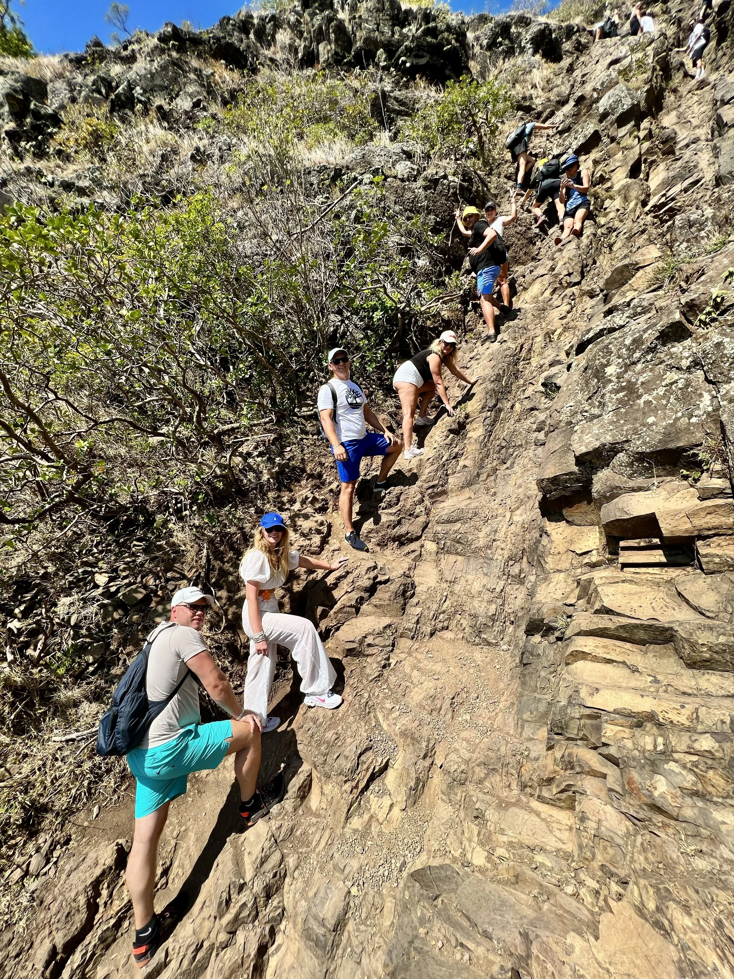 Group of hikers scaling a rocky hillside