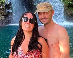 Couple standing in front of a waterfall