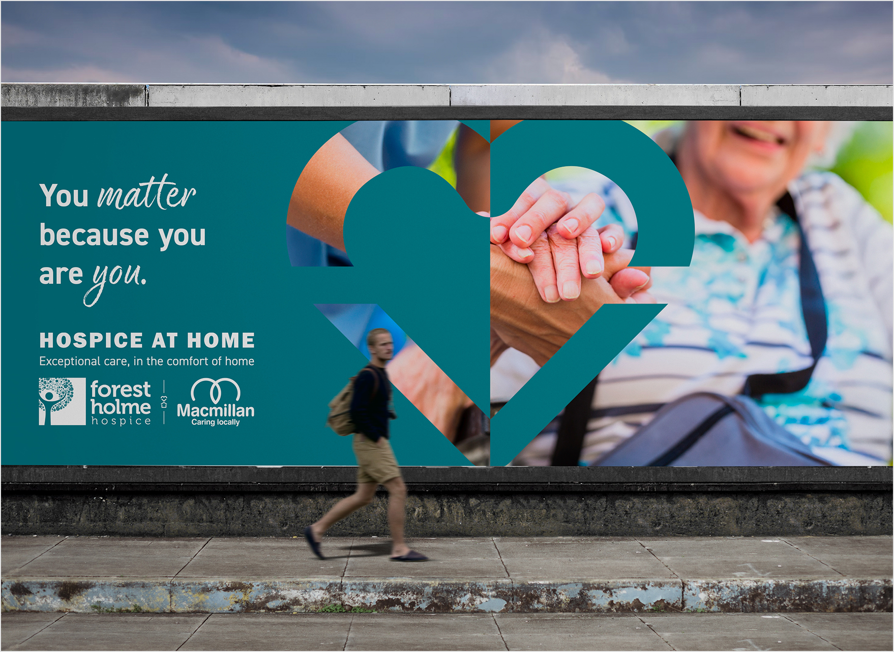 A street advertisement for hospice services featuring a large heart graphic, a close-up of two hands clasped in support, and a smiling elderly person. The ad includes logos for Forest Holmes Hospice and Macmillan, with the message: "You matter because you are you. Hospice at home. Exceptional care, in the comfort of home."