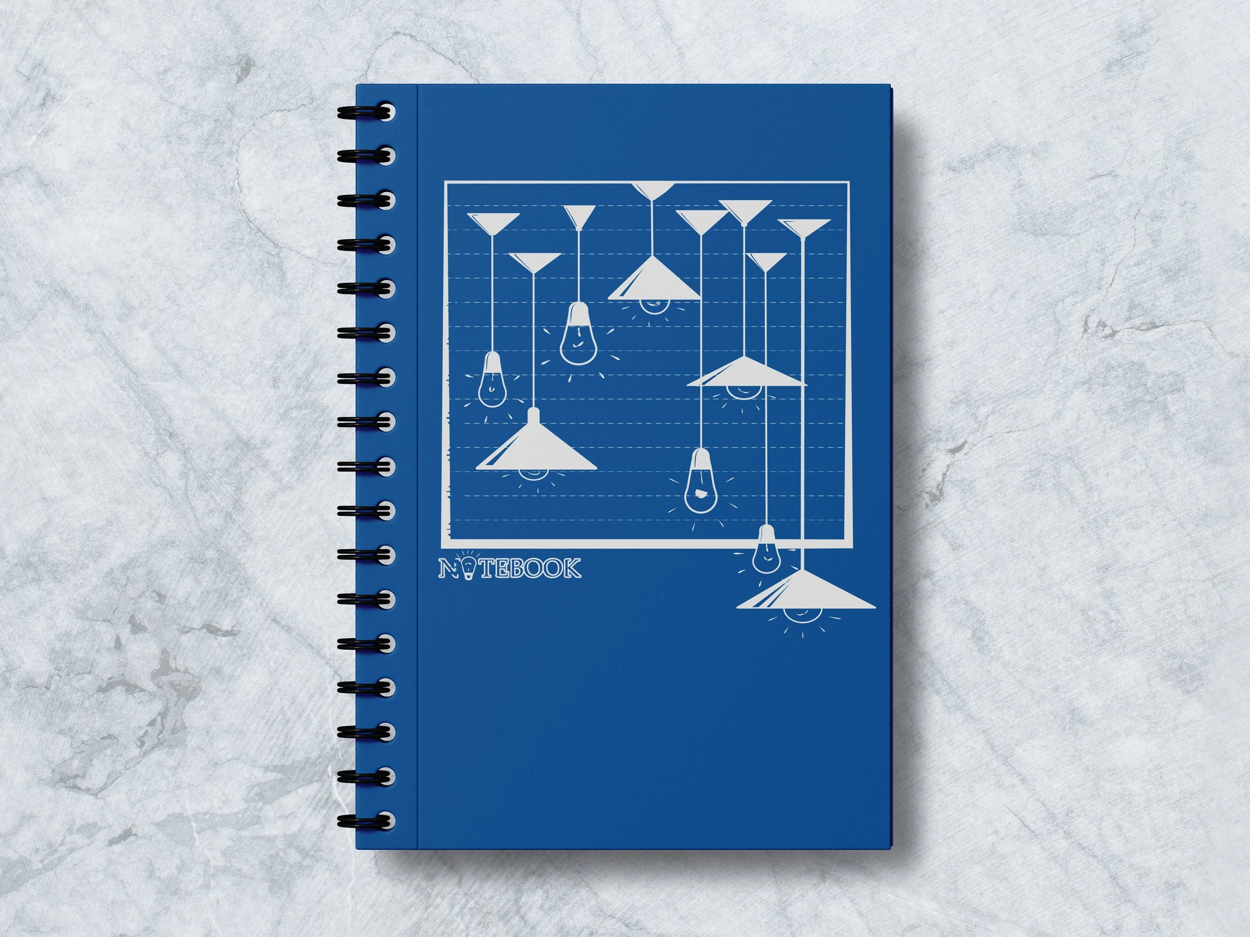 Blue spiral-bound notebook with white line drawings of hanging lamps and the word 'NOTEBOOK' on the cover, placed on a gray textured surface.