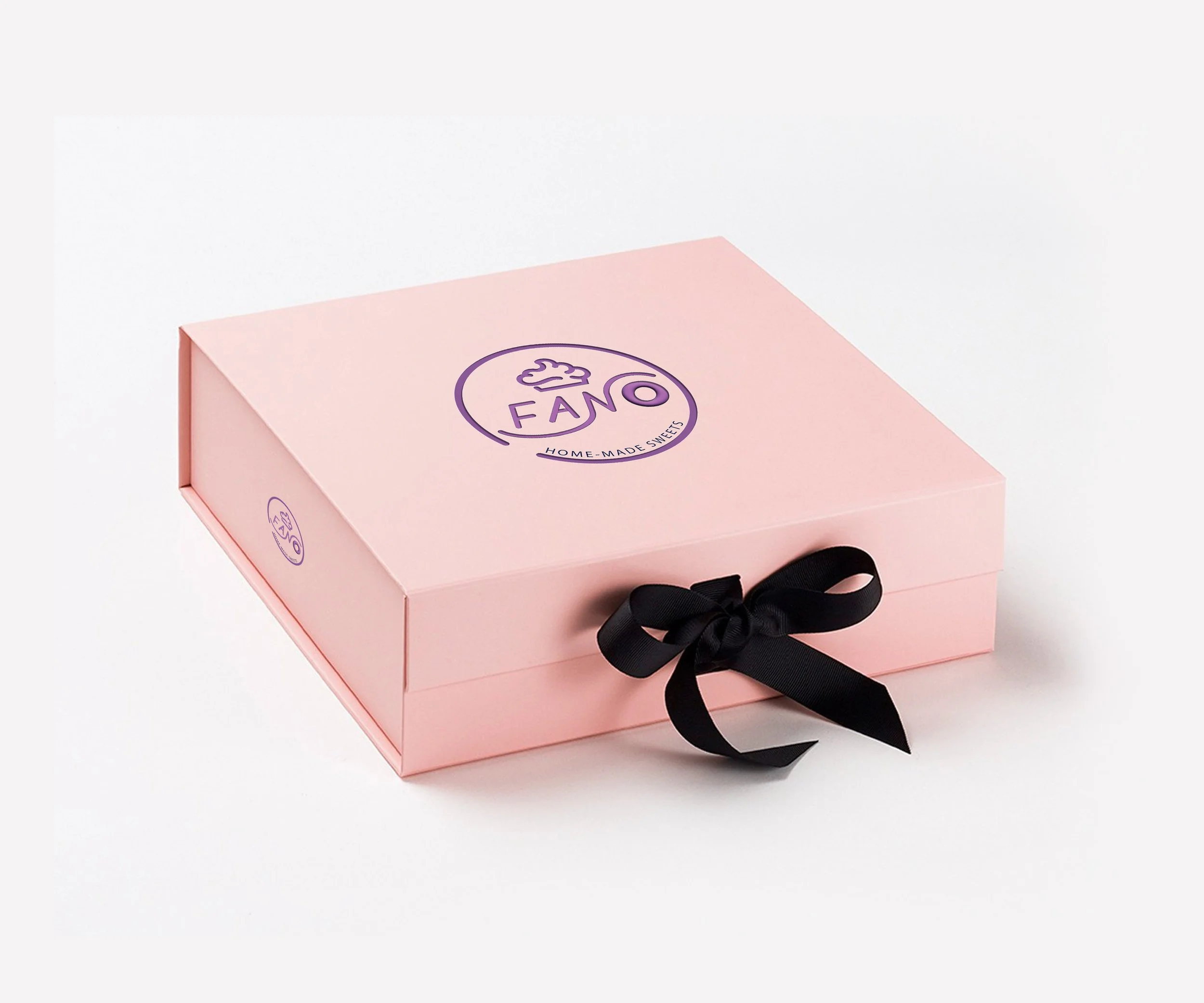 A pink box with black ribbon and purple logo, labeled 'Fano Home-Made Sweets' on a white background.