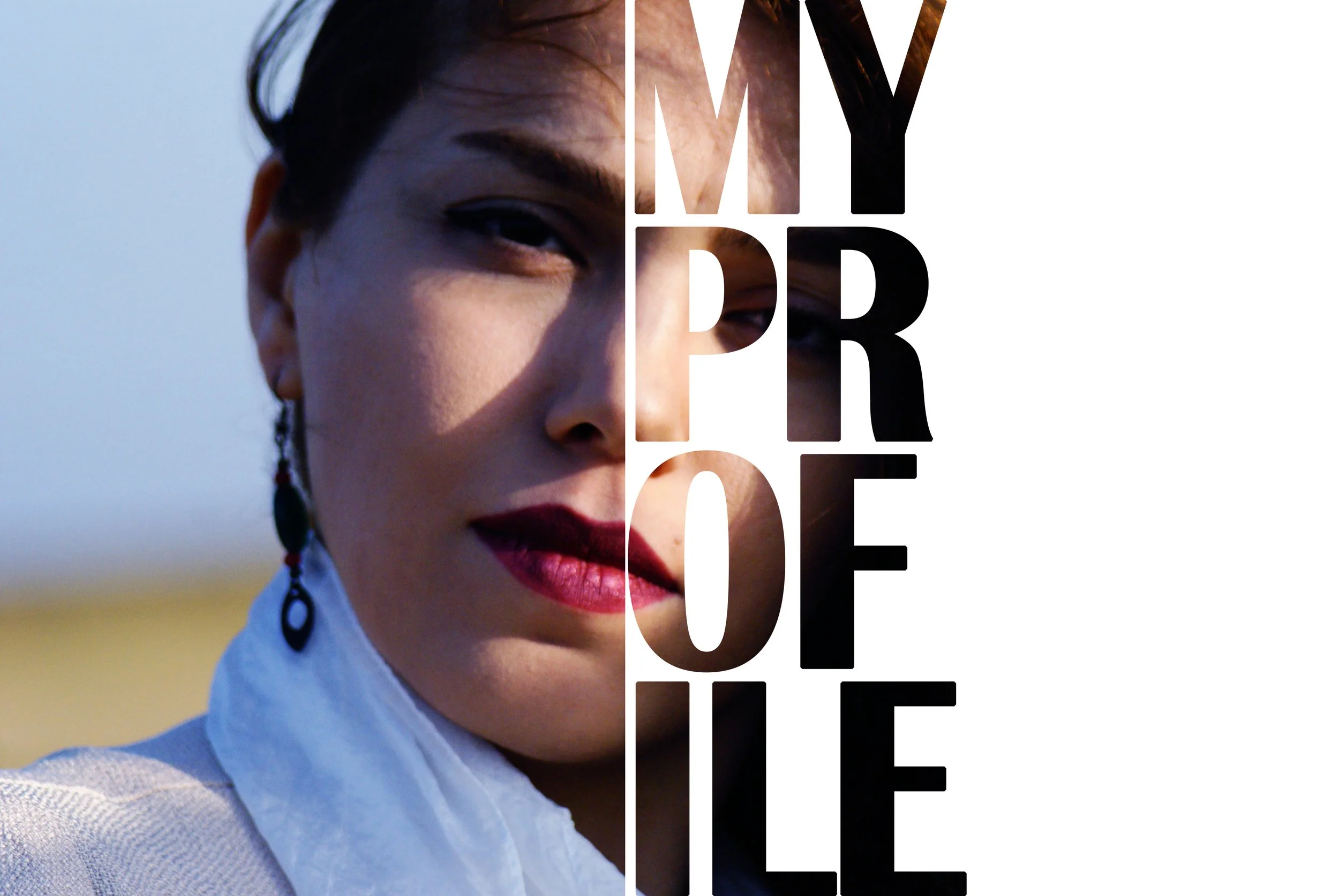 Close-up of a woman with dark hair, wearing earrings and a white top, with the words 'My Dream' overlayed in large black and white text.