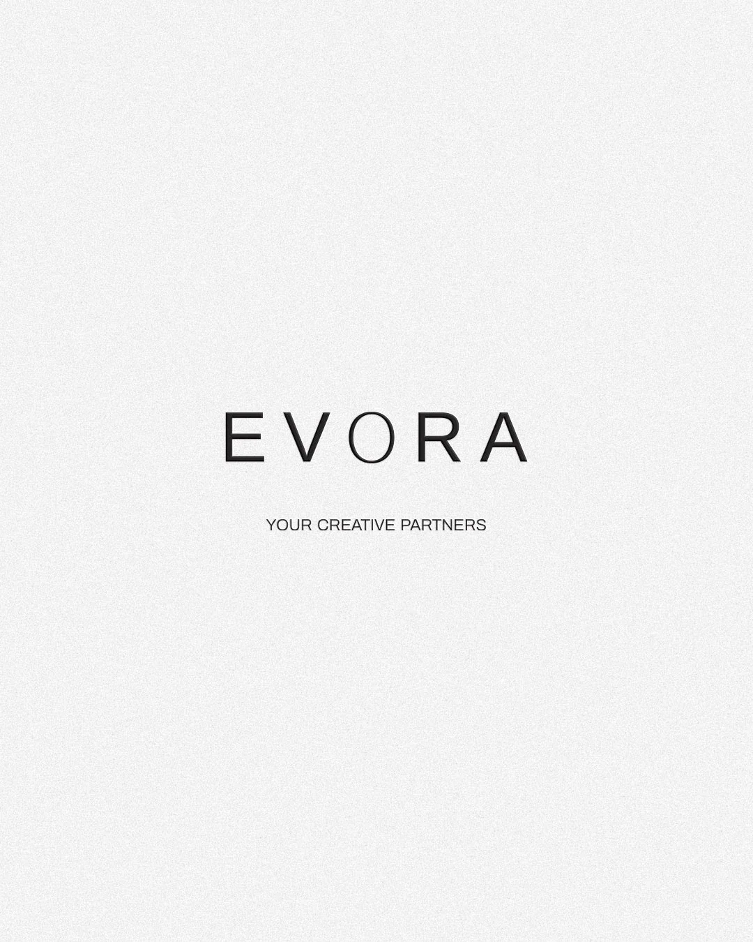 Centered text on a plain background displaying the brand name 'EVORA' and the slogan 'Your Creative Partners'.