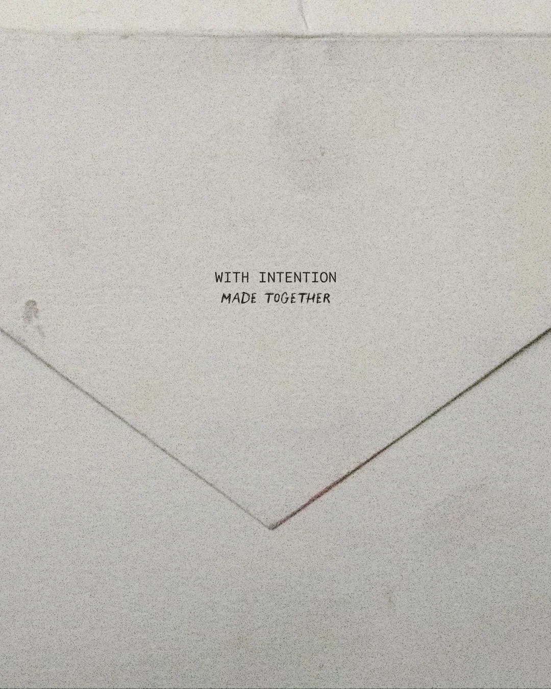 A white envelope with the words "WITH INTENTION MADE TOGETHER" written on it.