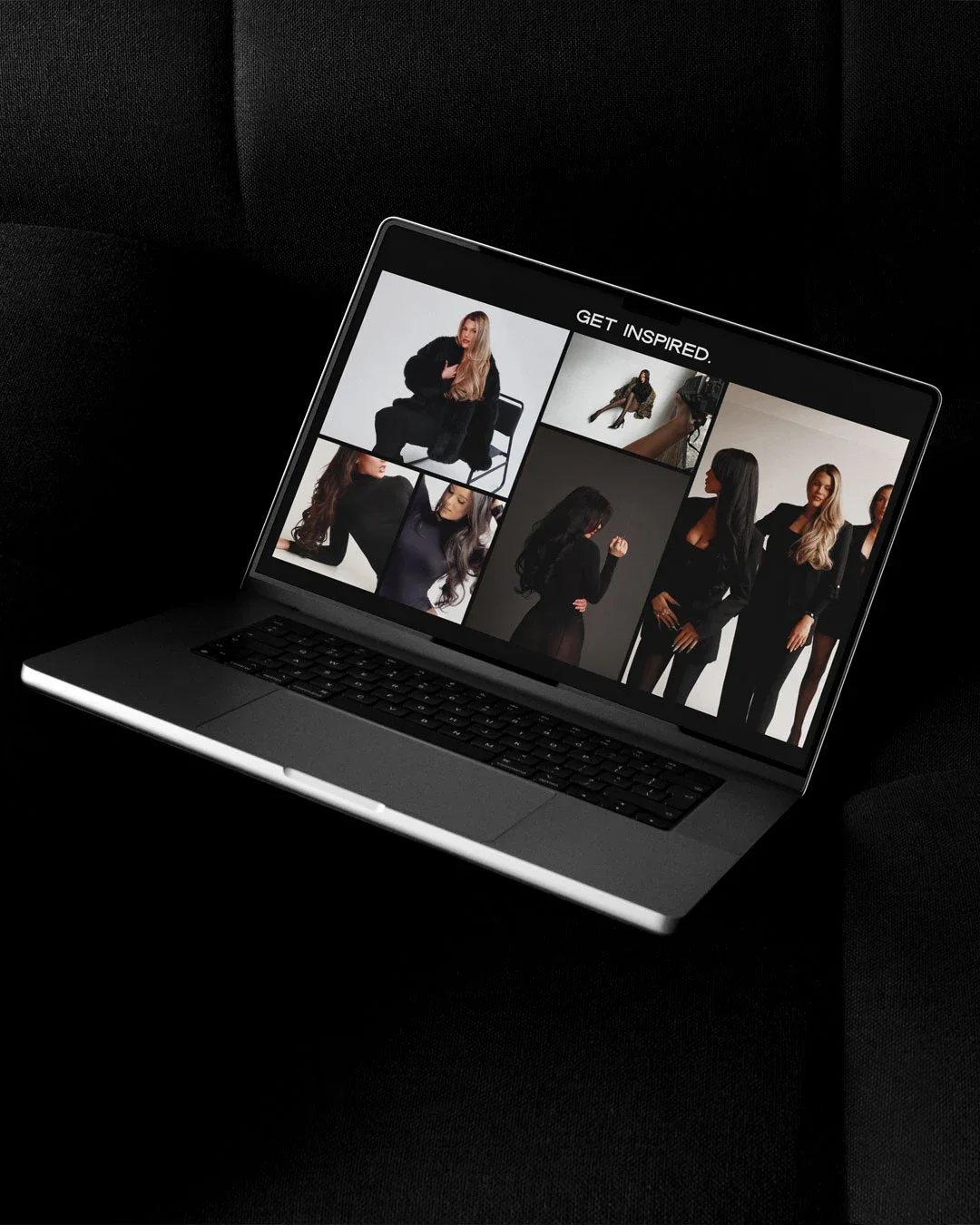 Open laptop on black surface displaying a photo collage of models in fashionable clothing with the text "GET INSPIRED" at the top.