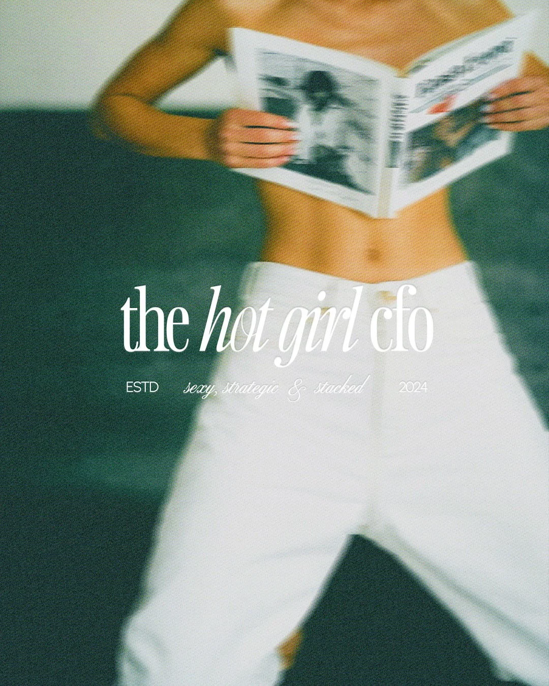 A woman in white pants and no top is holding an open magazine or book over her chest, with her upper body and midsection visible. The focus is on her torso and hands.