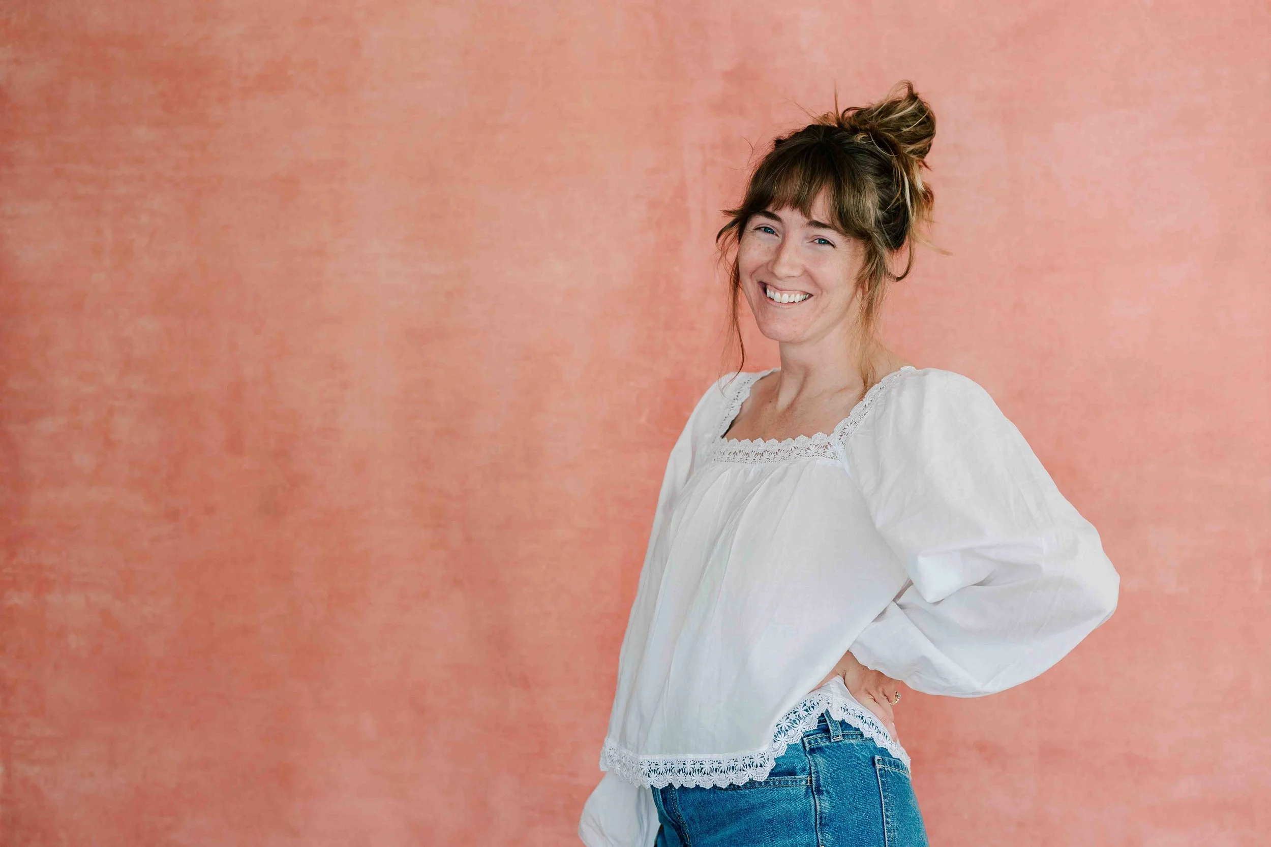 Woman smiling with hand on hip