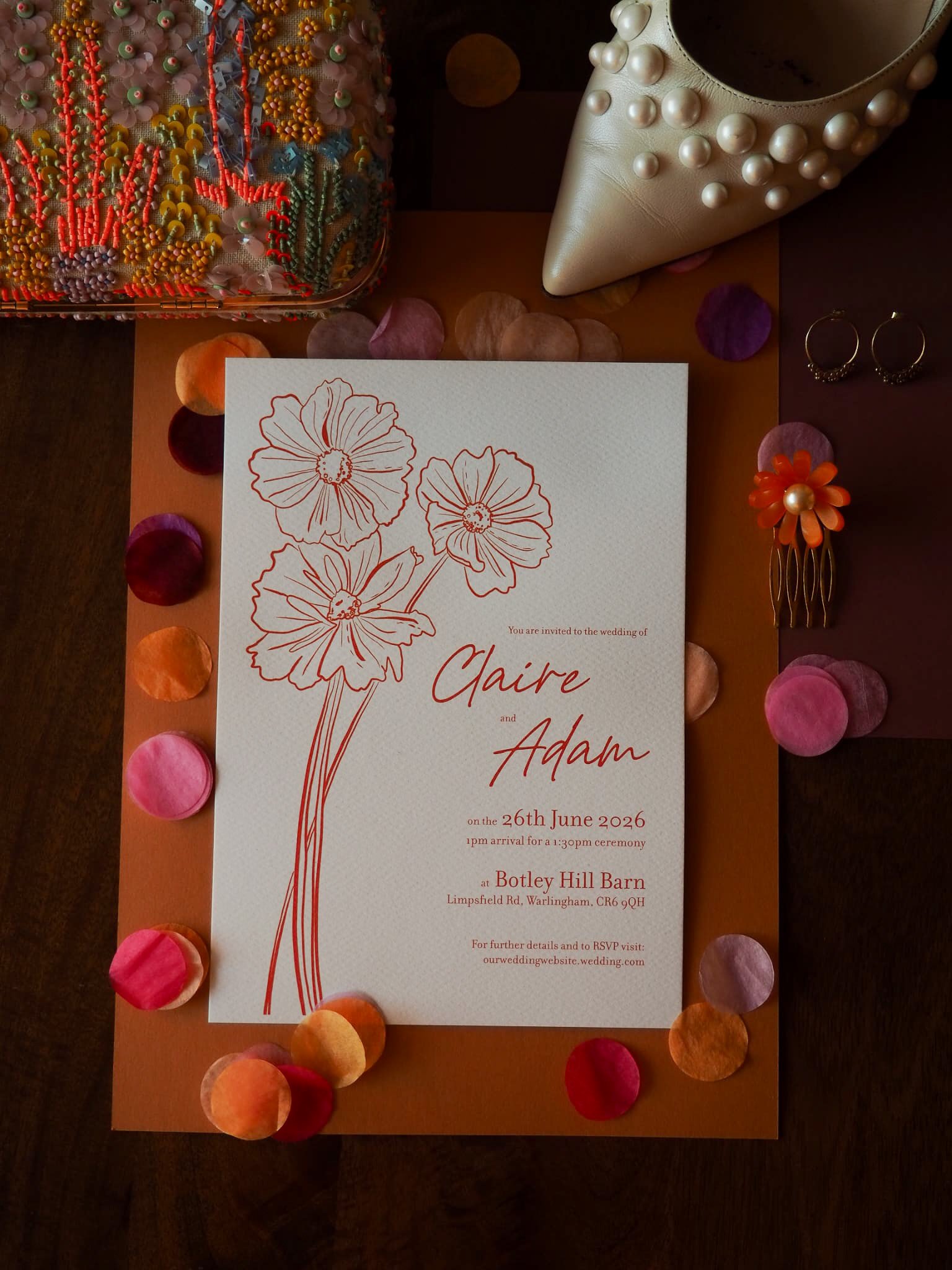 Wedding invitation with floral design, inviting Claire and Adam to their wedding on June 26, 2026, at Botley Hill Barn in Warlingham.