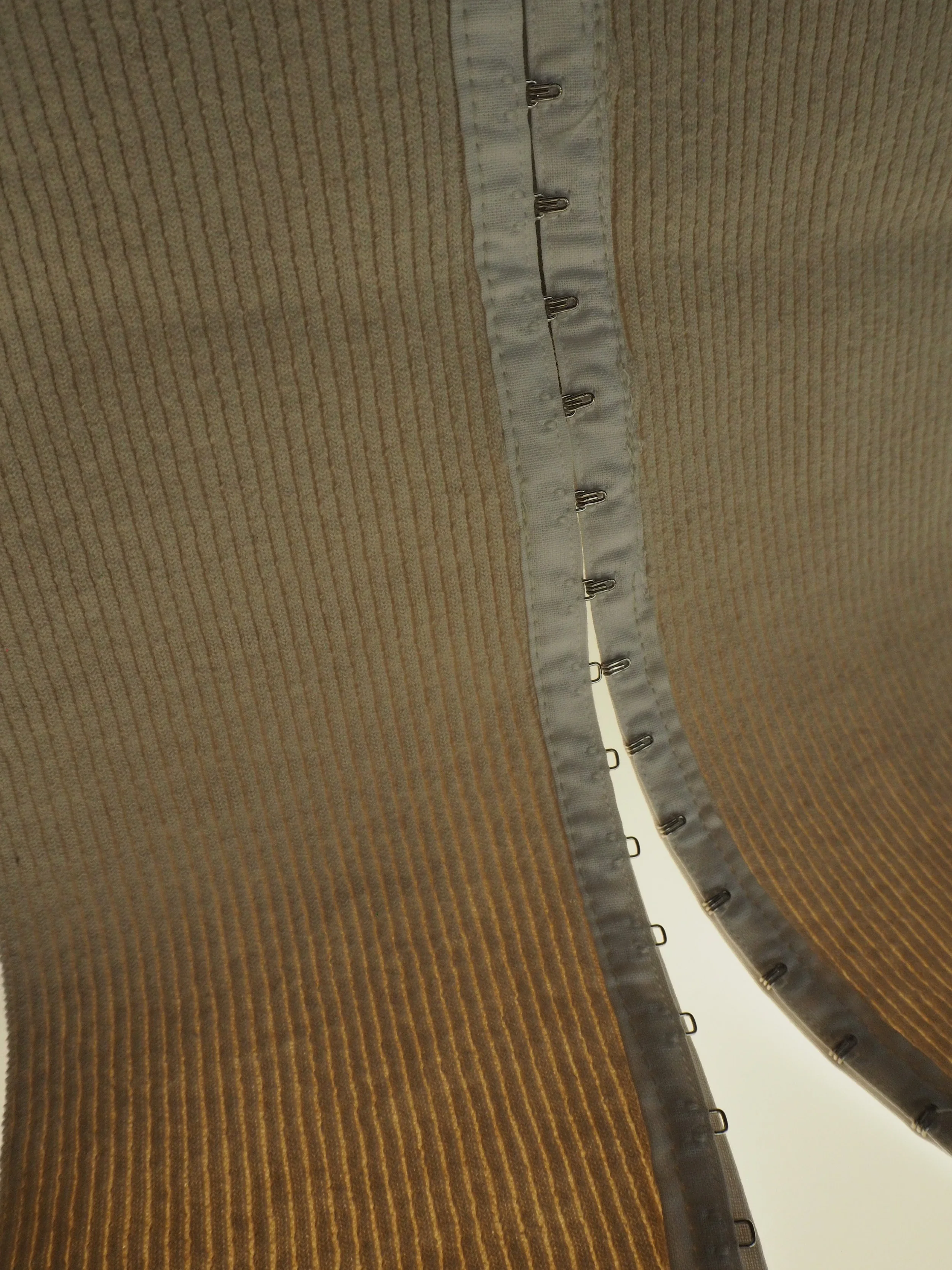 close-up photo of knitwear with hook & eye detail