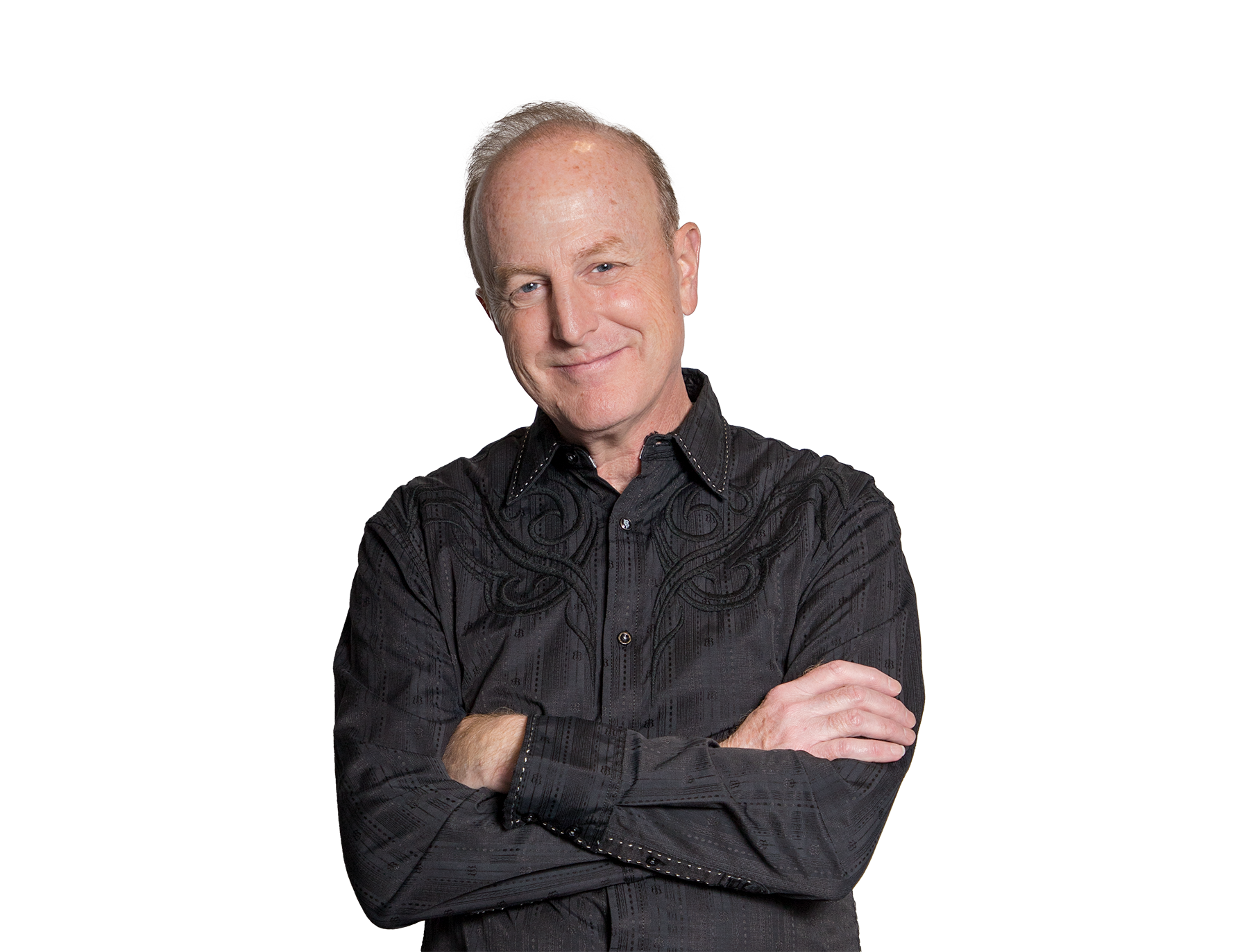 Ventriloquist David Pendleton in a black shirt with arms crossed.