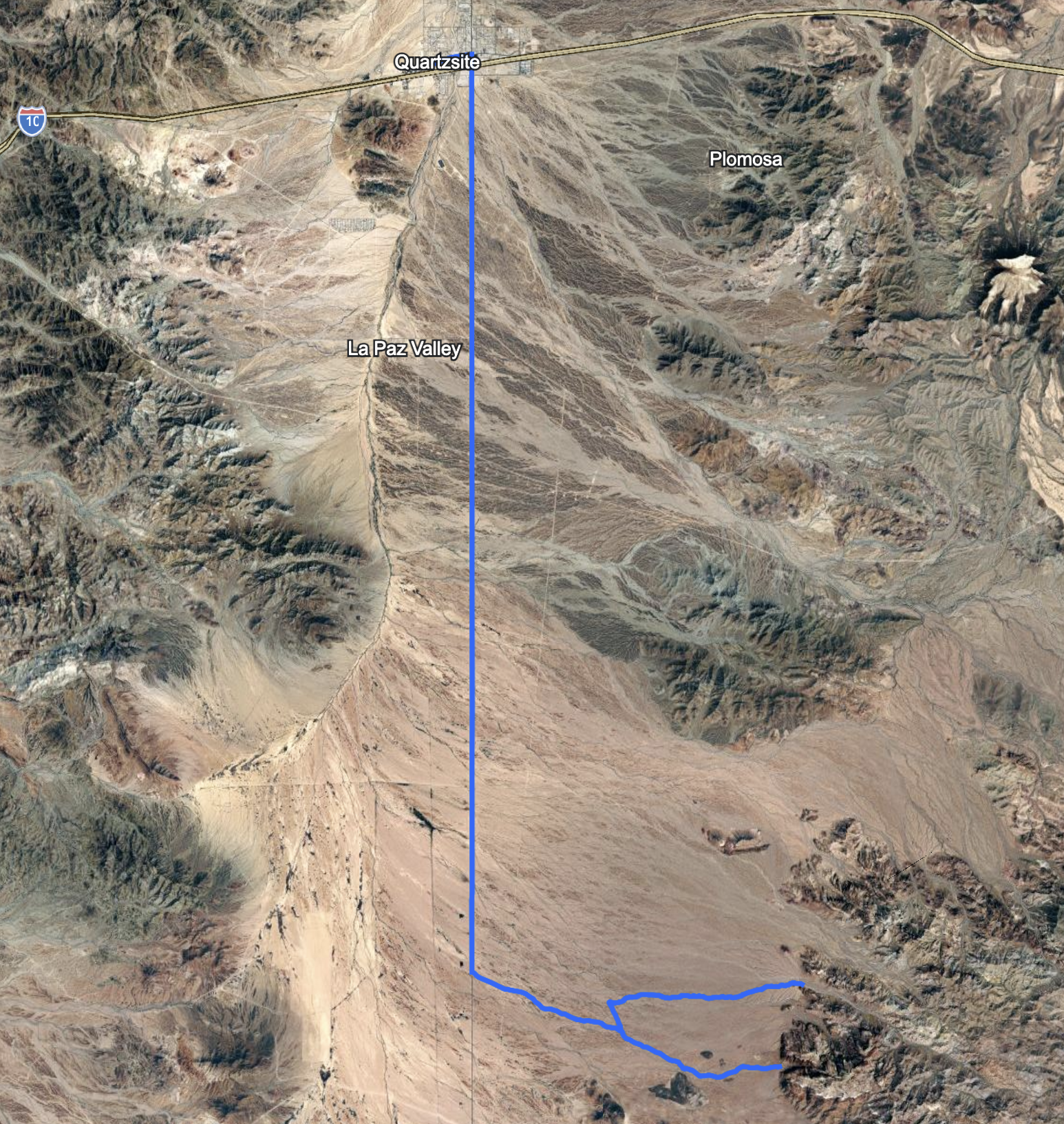 Map showing a trail in Kofa Wilderness with a red line crossing a desert area, passing near Signal Peak, and connecting to nearby canyons, springs, and landmarks.