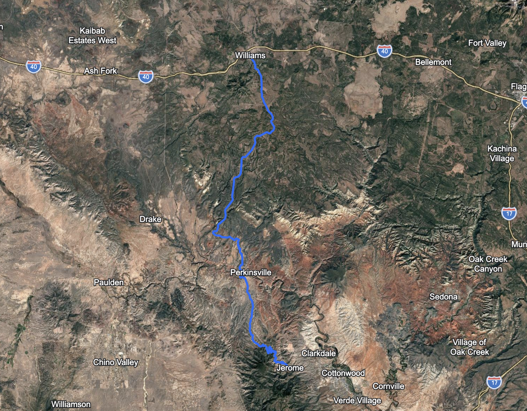 Map displaying a hiking trail through national parks, including Woodchute Wilderness, Sycamore Canyon Wilderness, and Tuzigoot National Monument, with terrain features and surrounding roads.