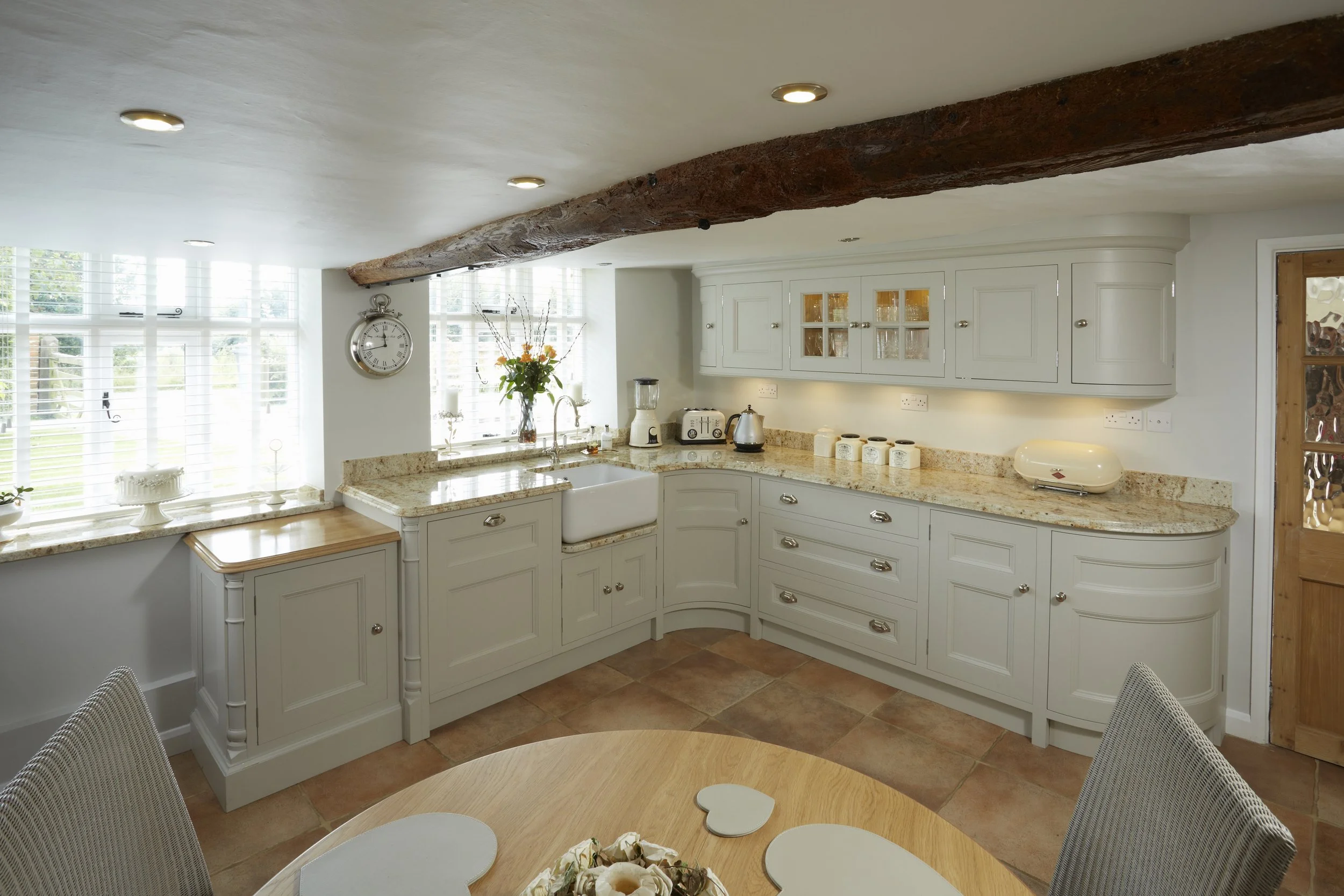 Bespoke country-style kitchen with painted cabinetry and granite worktops
