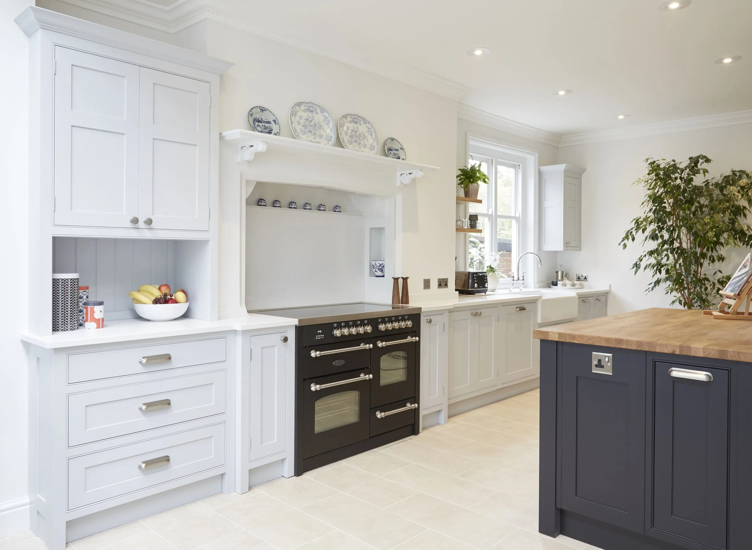 Modern kitchen with neutral cabinetry and contrasting statement island with breakfast bar