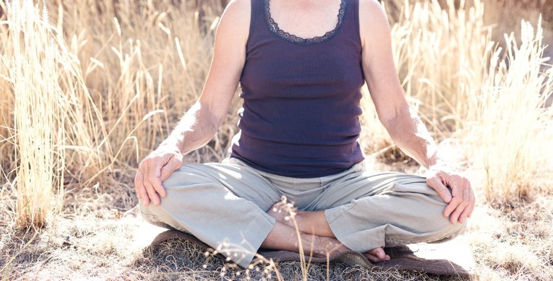 Woman meditating in a field