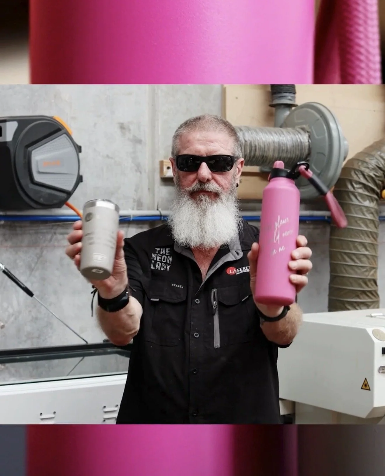 Russell showing off his lasered coffee cup and hot pink water bottle